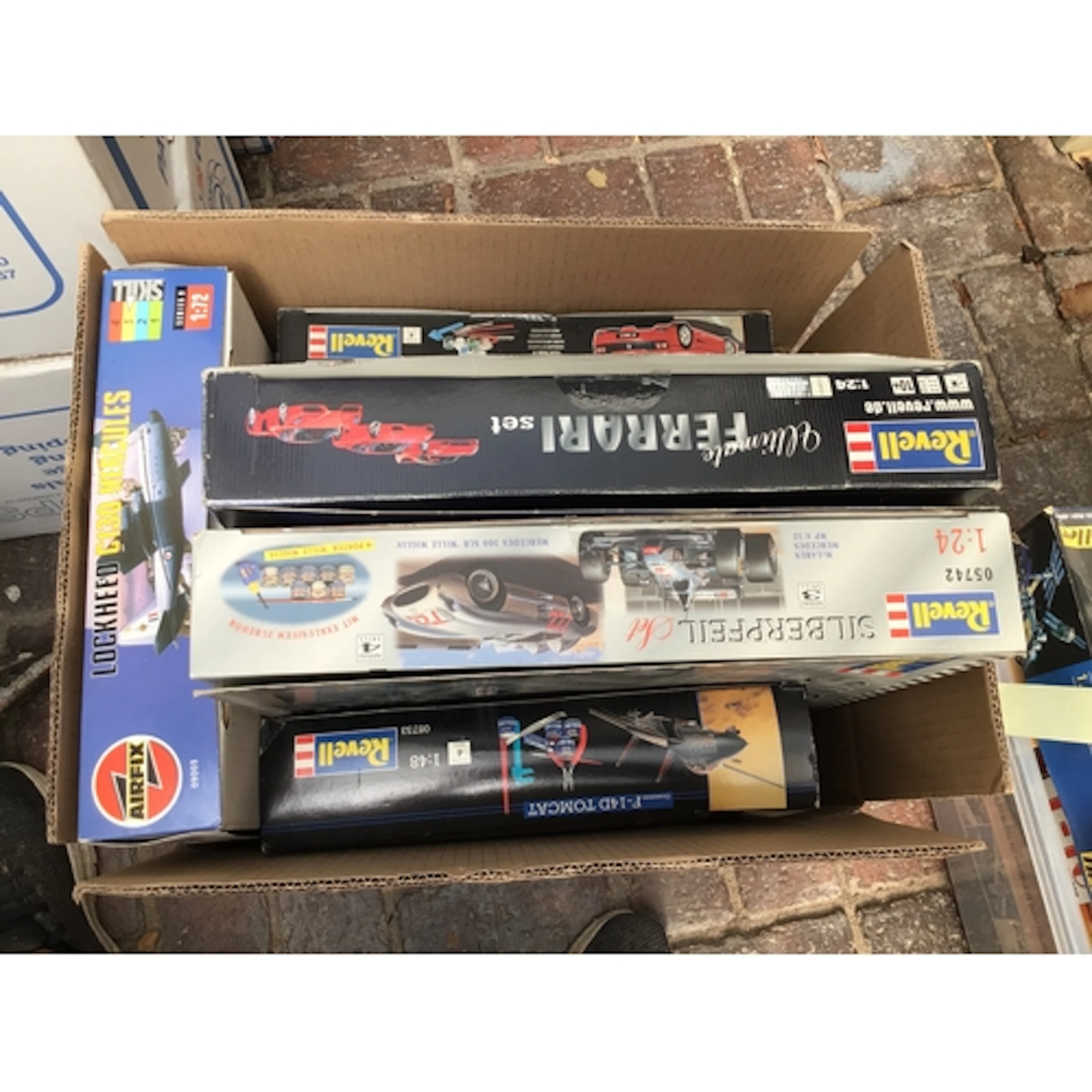 A collection of boxed model kits featuring aircraft and cars...
