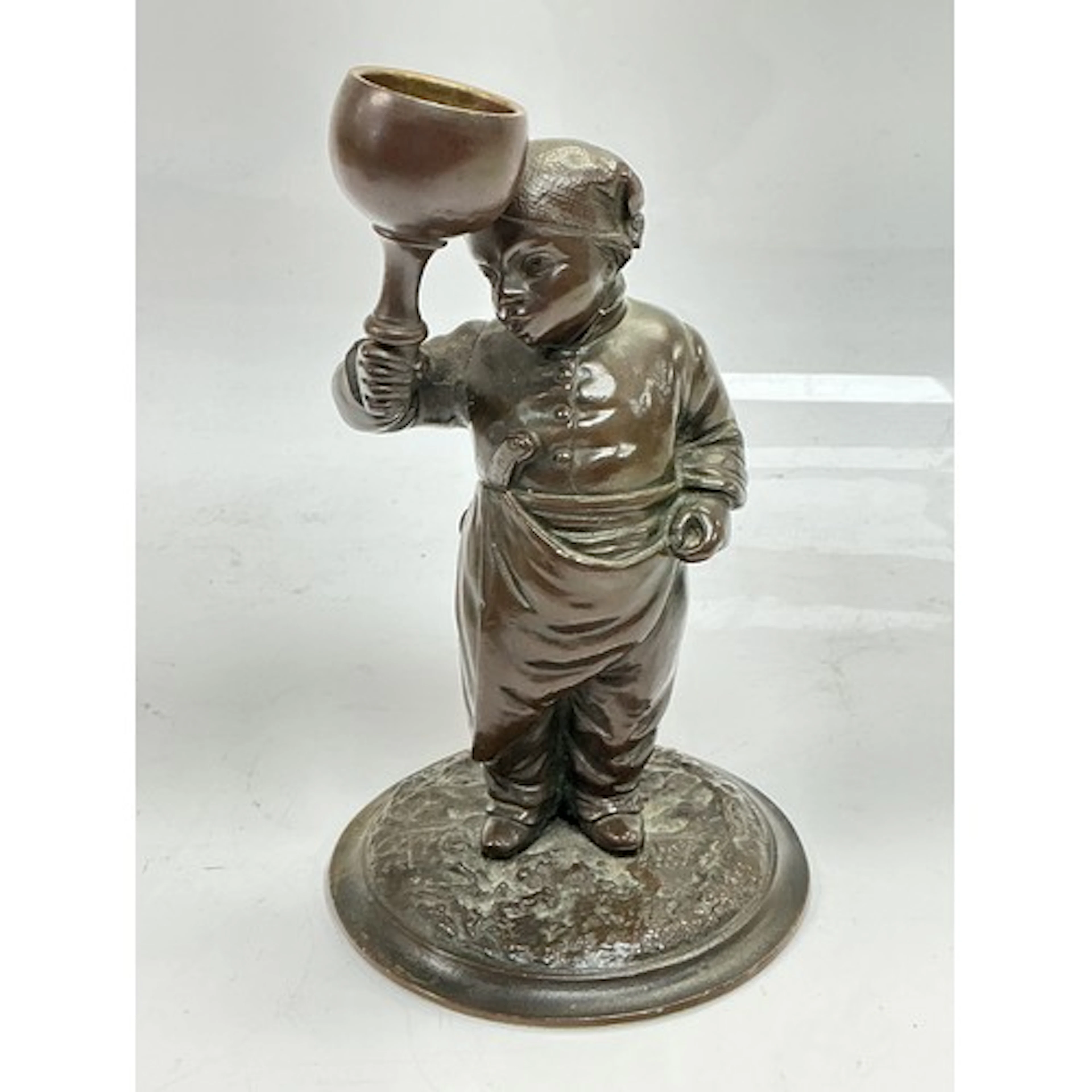 A small bronze figural candlestick of a late 19th Century tr...