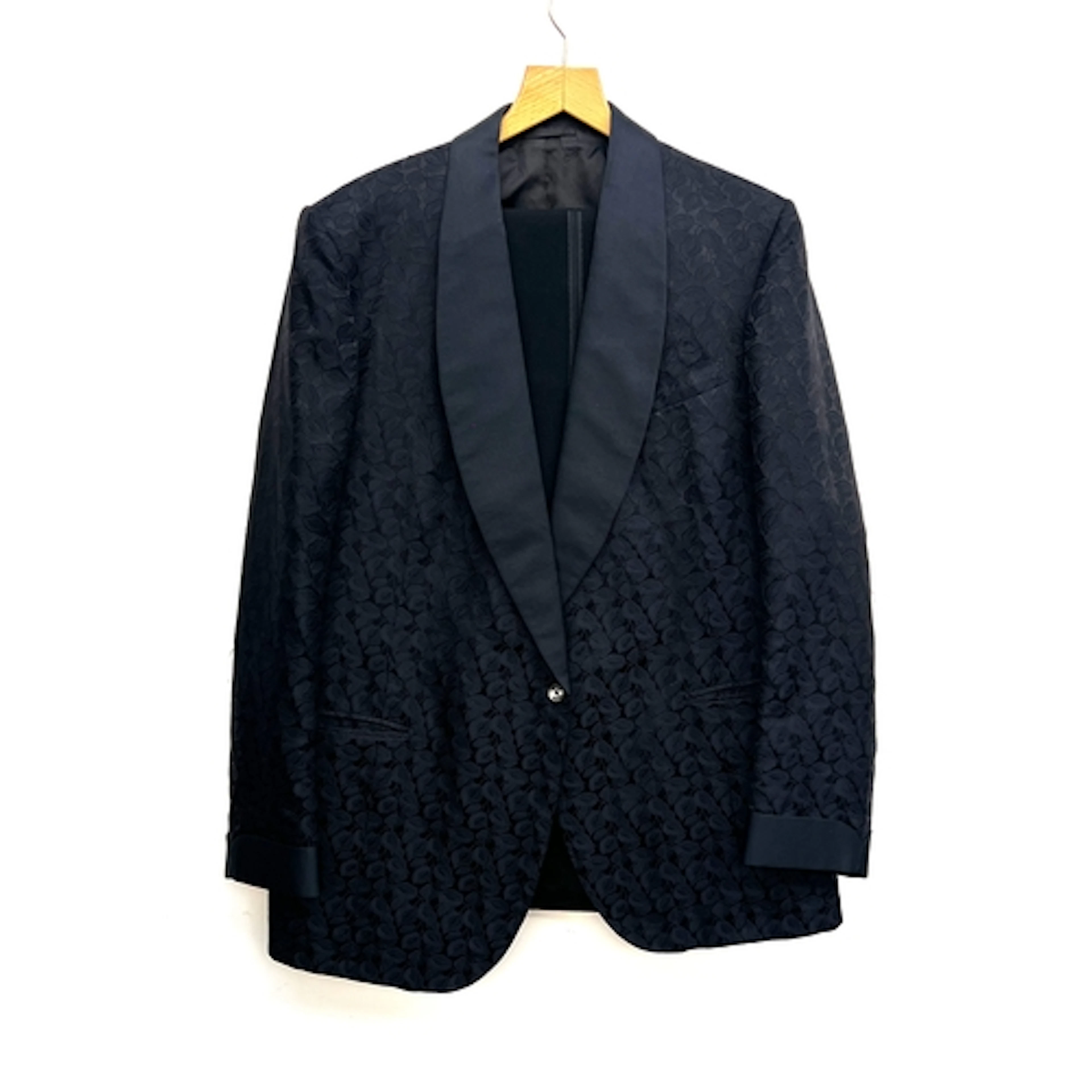 A dinner jacket in a damask black fabric and shawl collar, t...