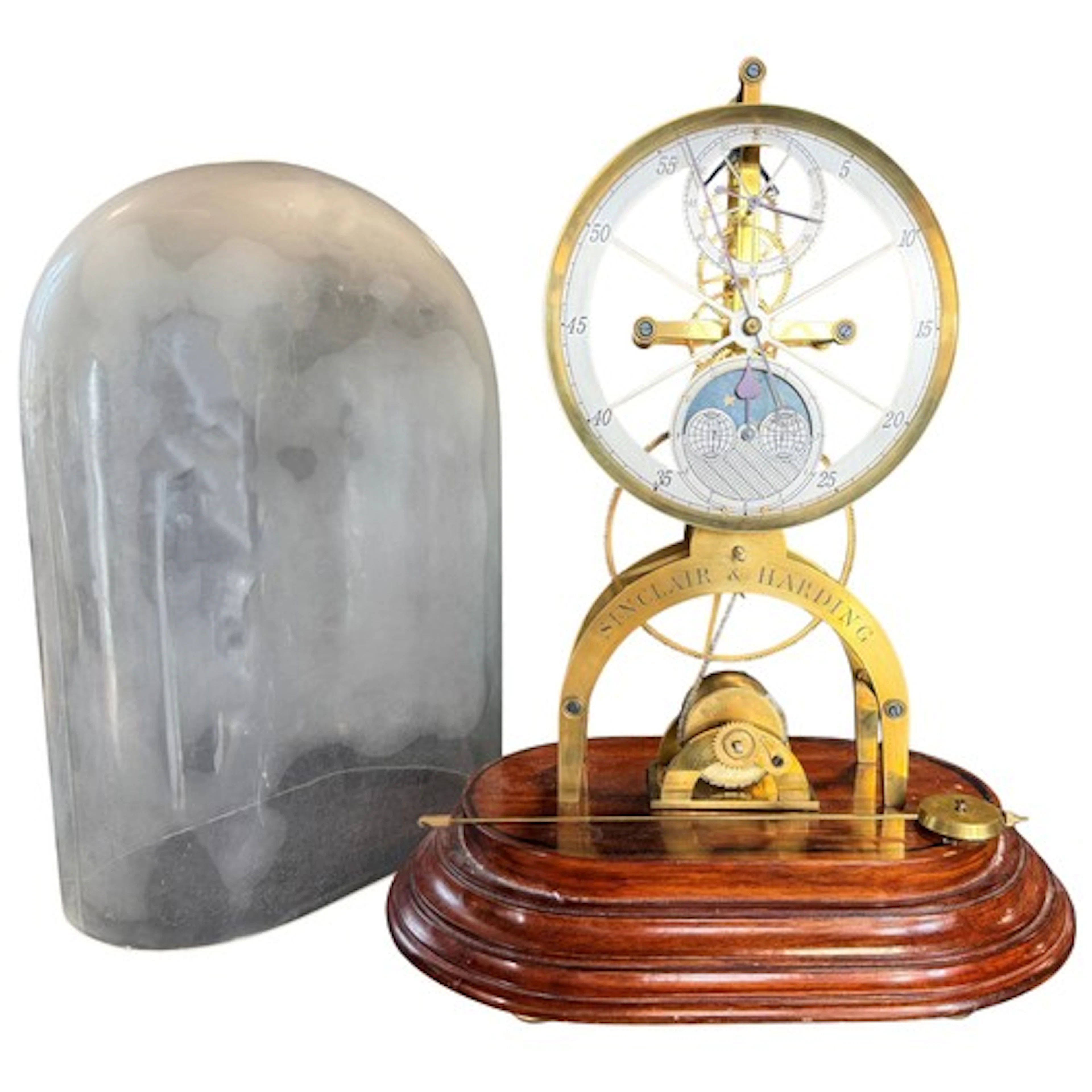Sinclair & Harding; a large brass skeleton clock under glass...