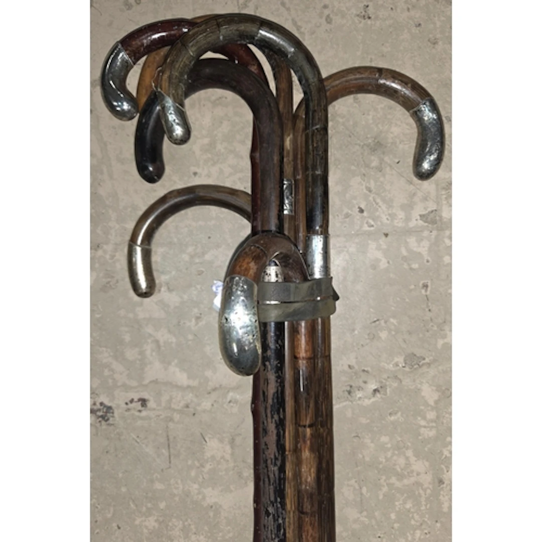 5 vintage walking sticks with silver handles.