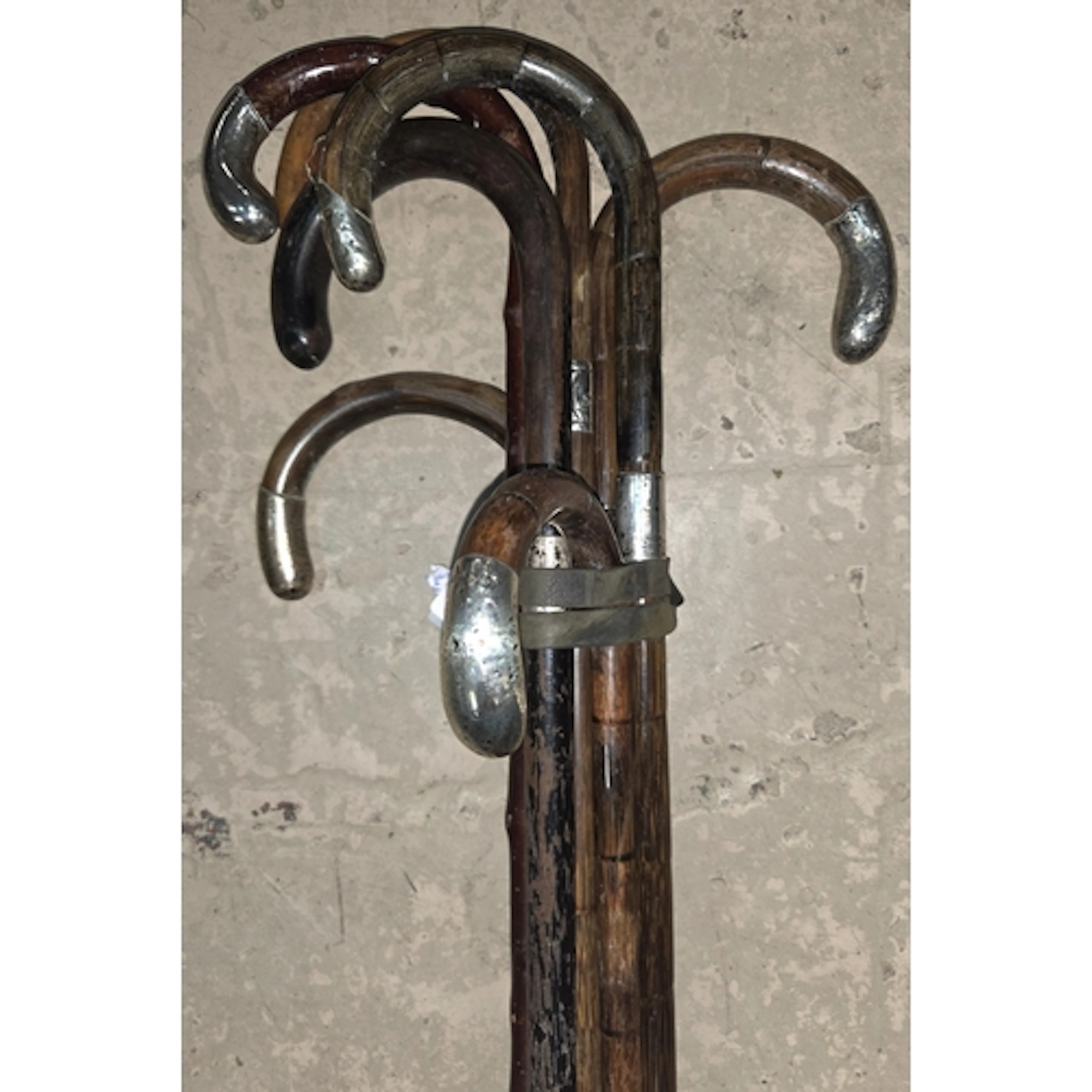 5 vintage walking sticks with silver handles.
