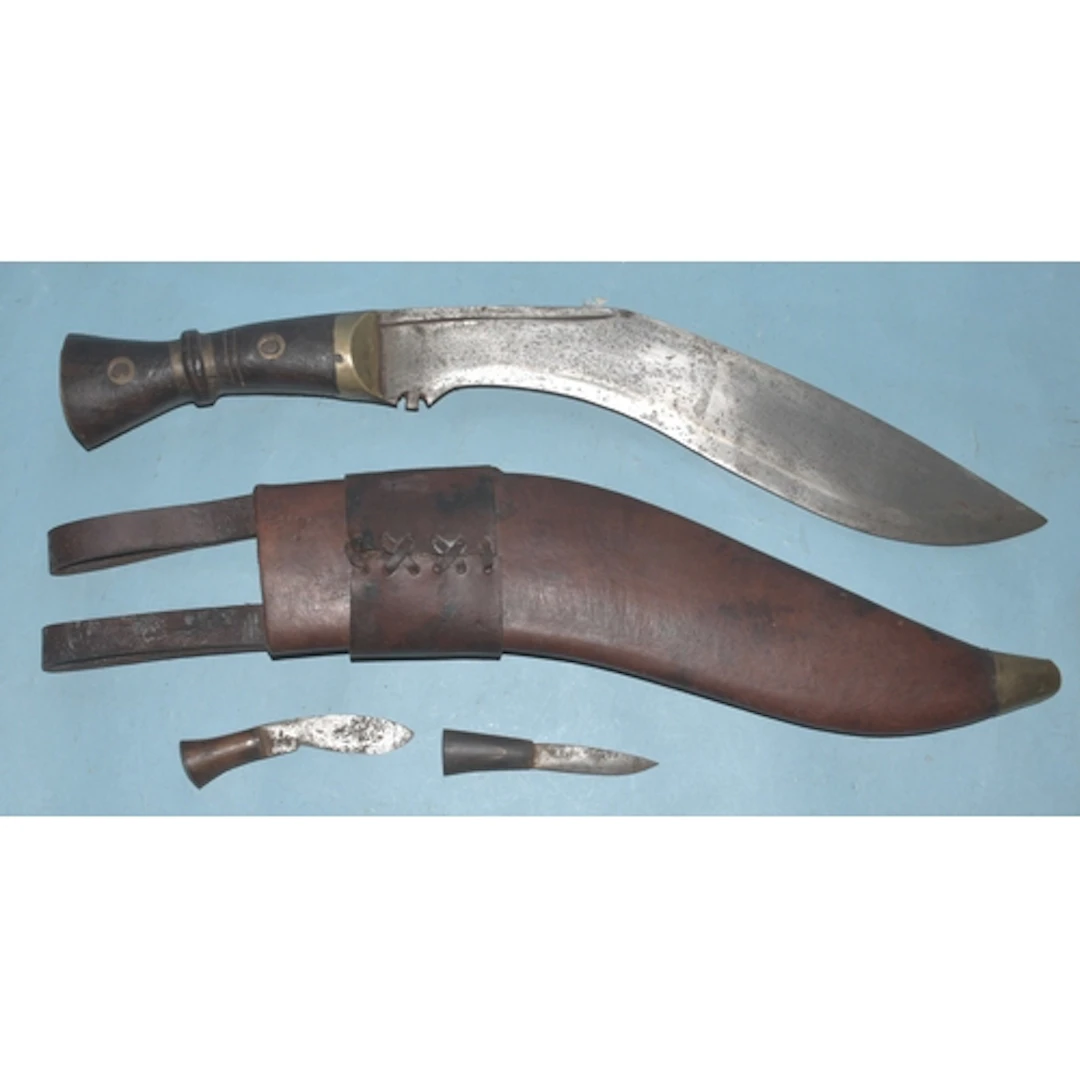 A Nepalese kukri knife in leather scabbard, with mismatched ...