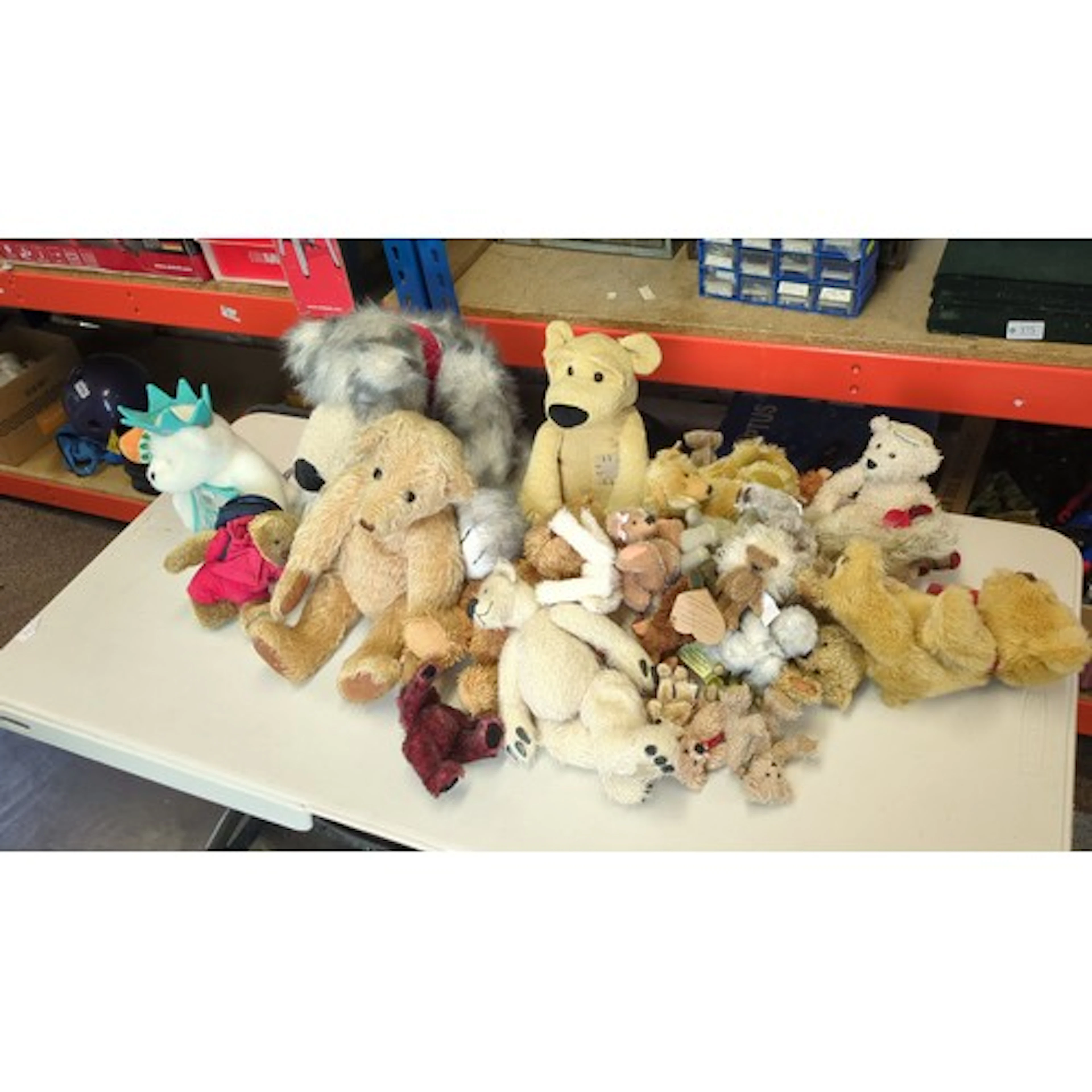 A collection of teddy bears and plush animal toys, including...