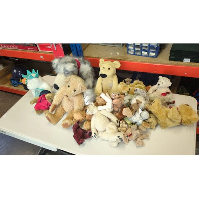A collection of teddy bears and plush animal toys, including...