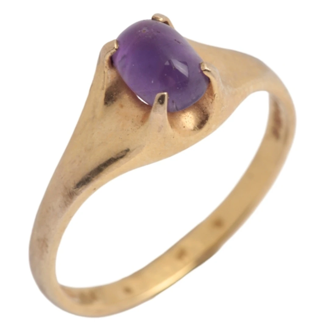 An amethyst ring, circa 1980, claw-set with a cabochon ameth...