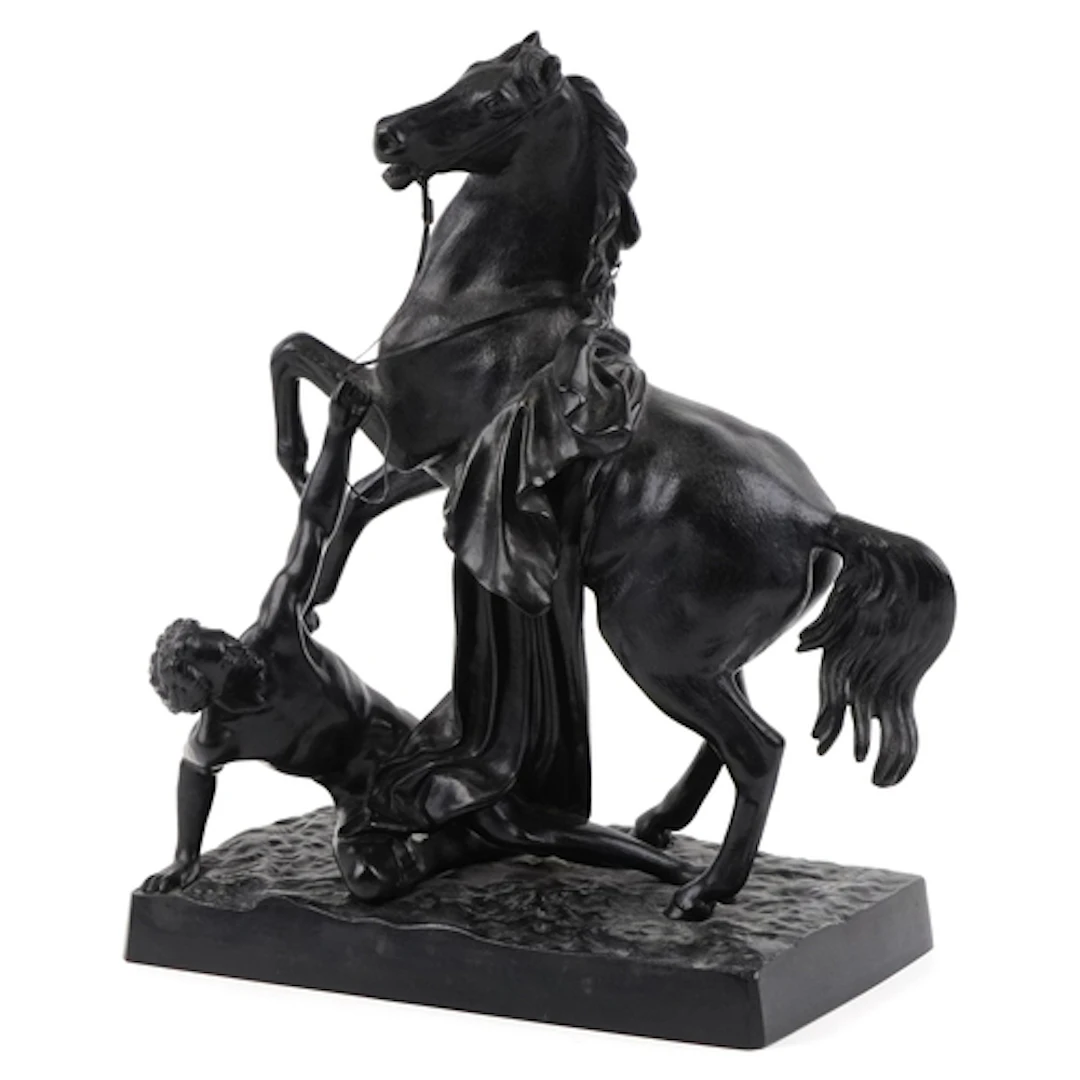 Black patinated cast iron sculpture of a rearing horse and f...