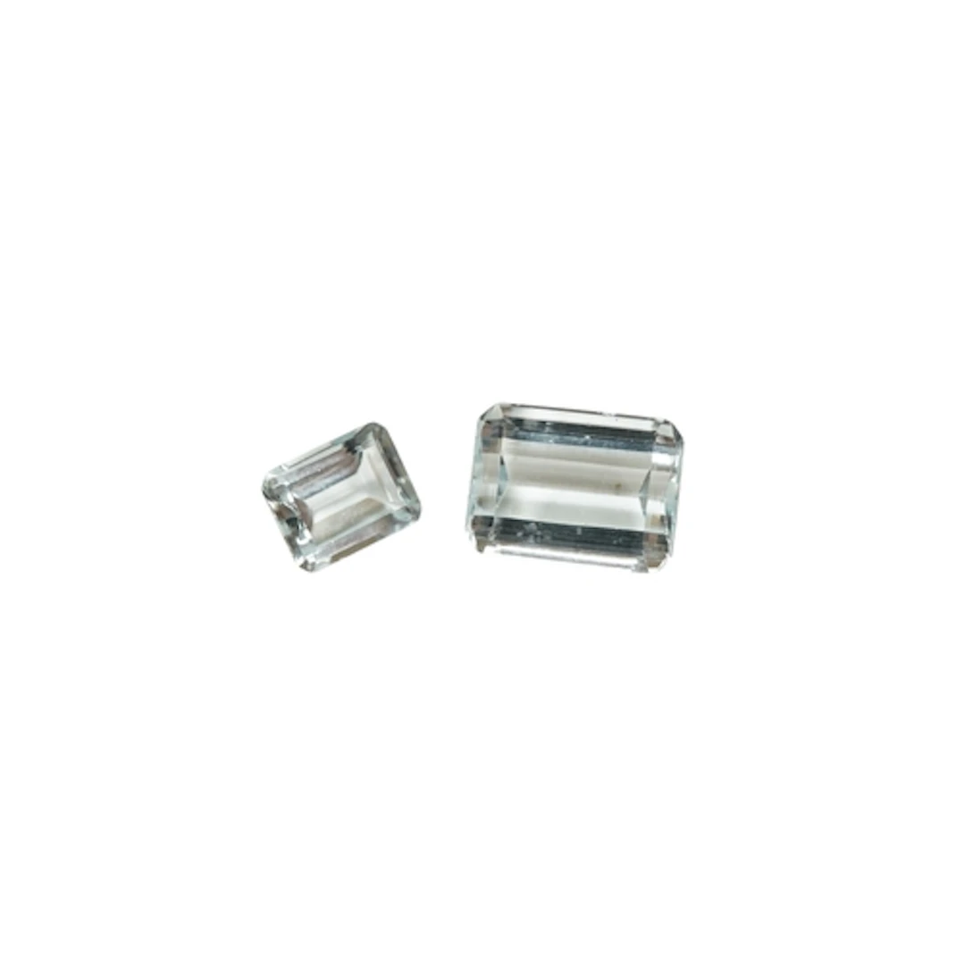 Two unmounted emerald cut aquamarine stones, weighing approx...