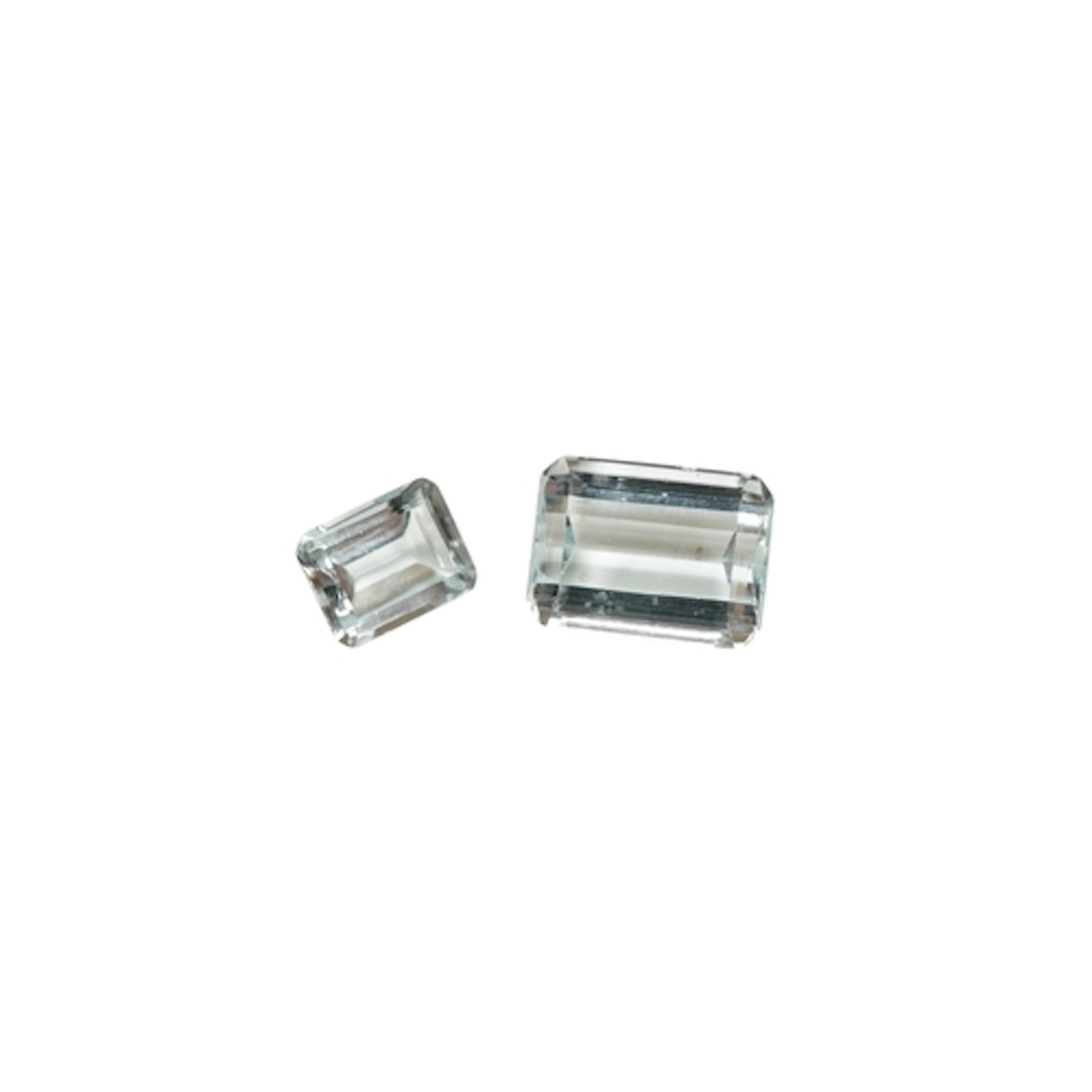 Two unmounted emerald cut aquamarine stones, weighing approx...