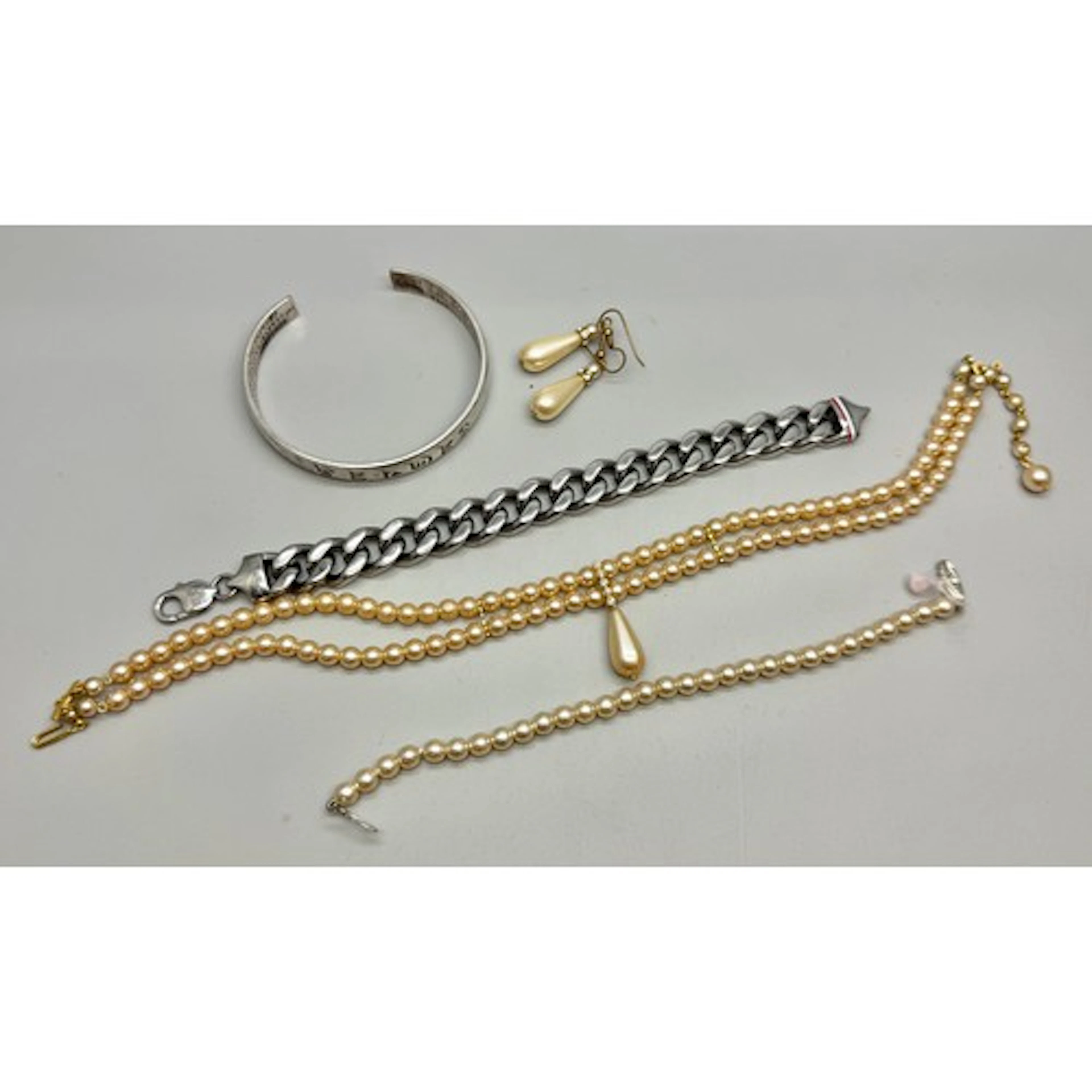 A silver plated bangle, a faux pearl set, and a plated Tommy...
