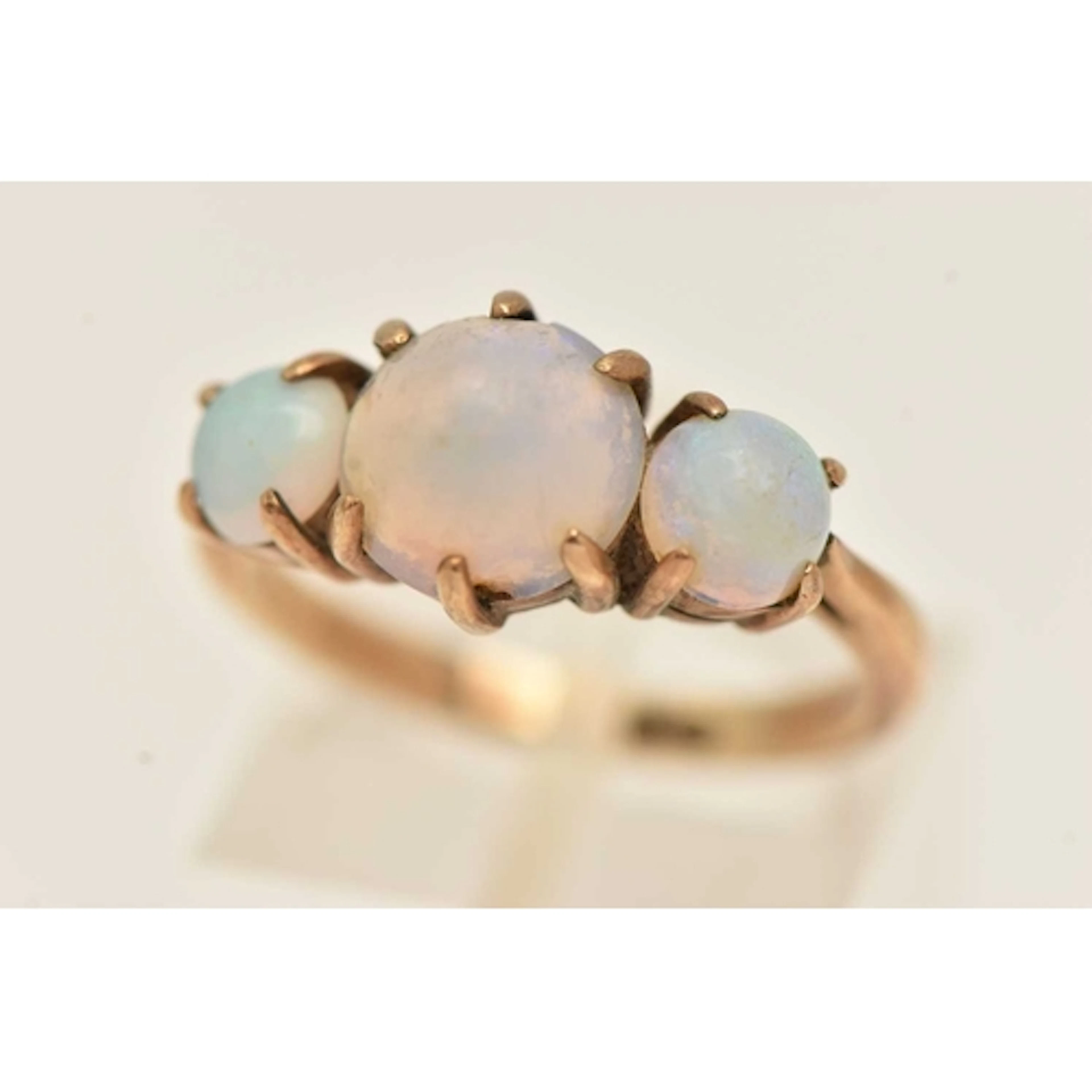 A YELLOW METAL OPAL RING, set with a central sugar loaf opal...