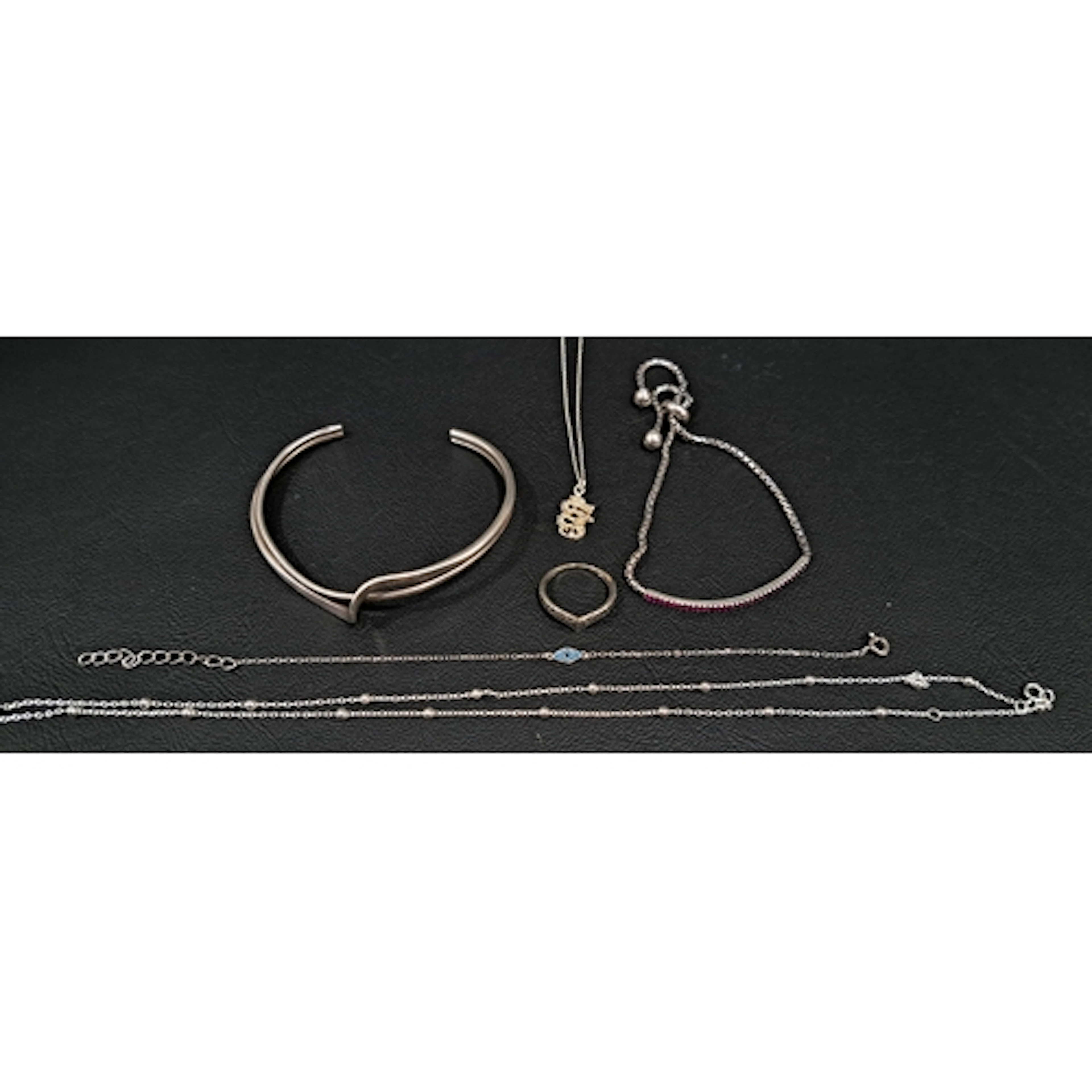 SIX PIECES OF SILVER JEWELLERY comprising a twist design ope...