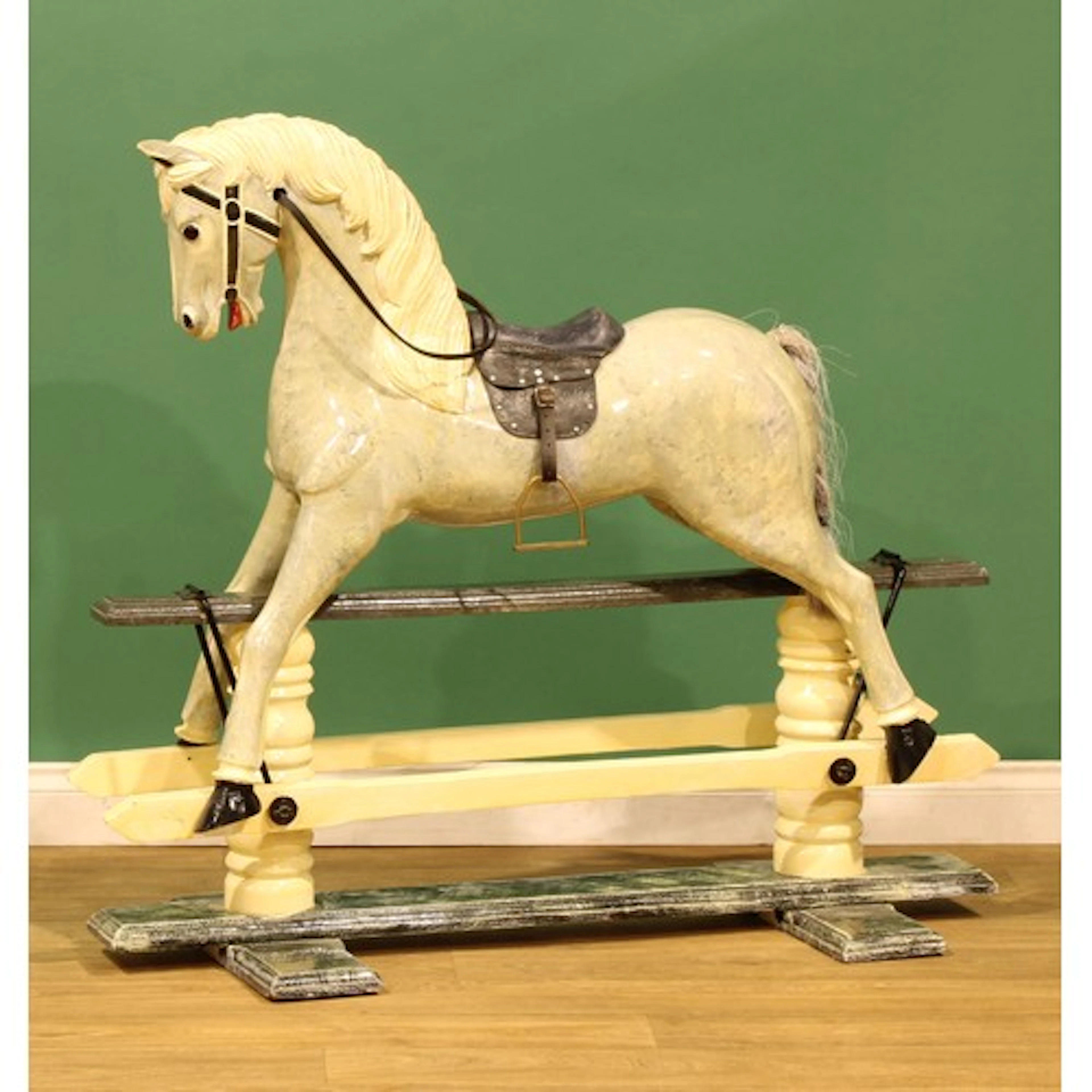 A 19th century style dappled grey rocking horse, the brass s...