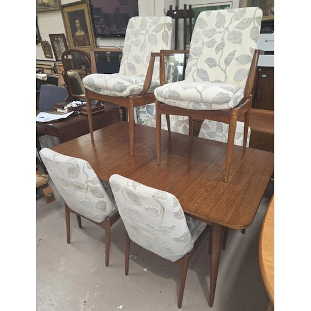 A mid century teak dining table and 6 chairs, overstuffed an...