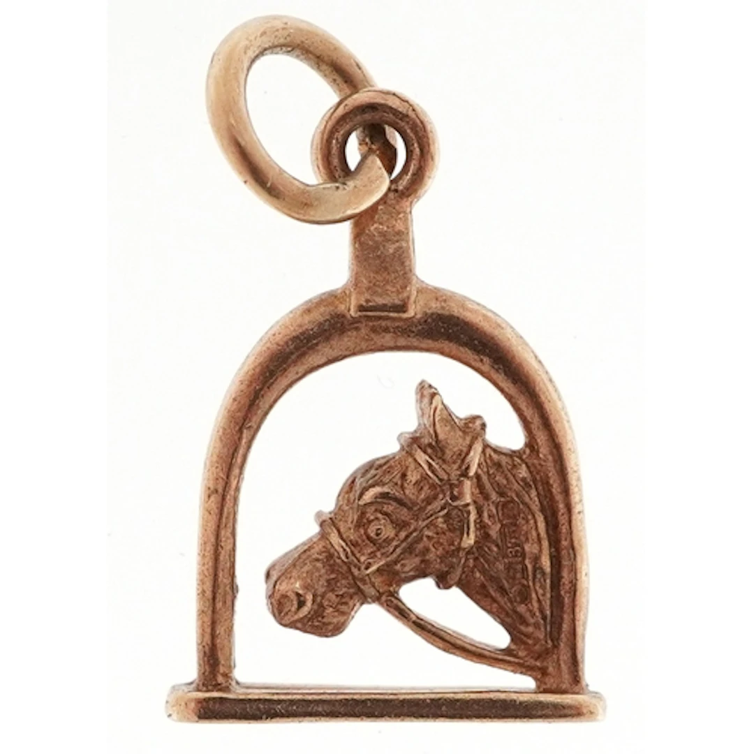 9ct gold charm in the form of a horse's head and stirrup, 1....