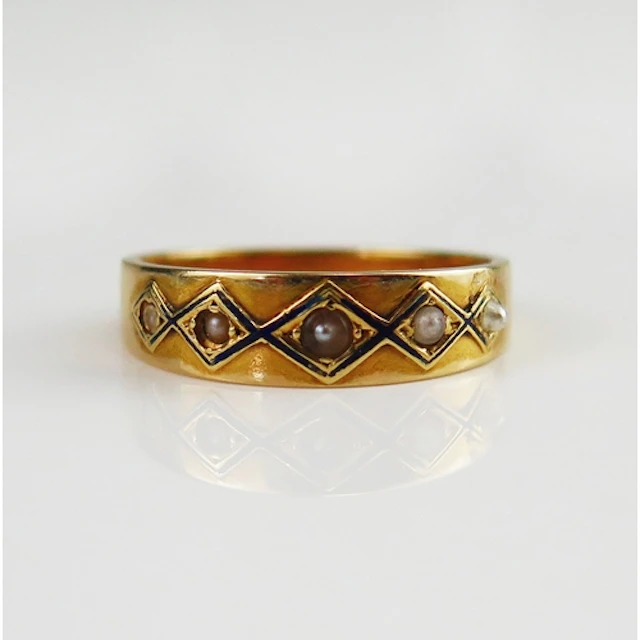 An antique enamel and seed pearl ring in a high carat precio...