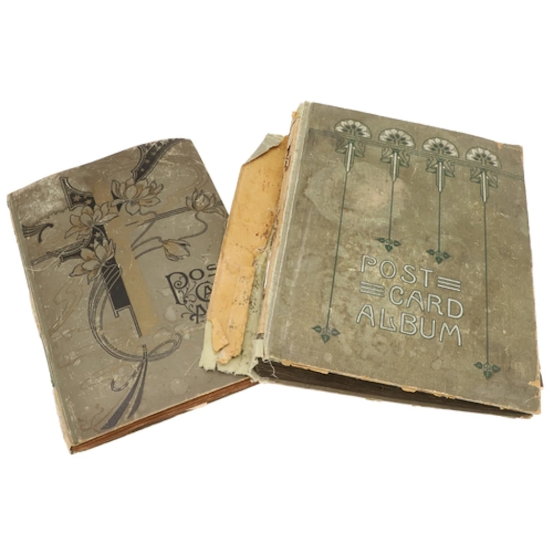 TWO VINTAGE POSTCARD ALBUMS. Two vintage postcard albums, in...
