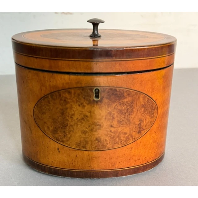 A late 18th century oval satinwood and burr walnut tea caddy...