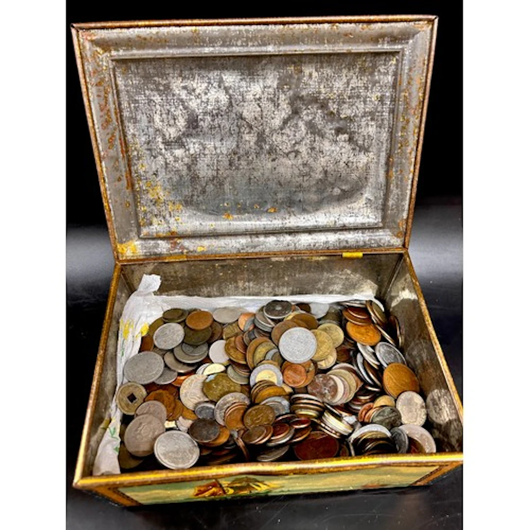 A tin of assorted world coins