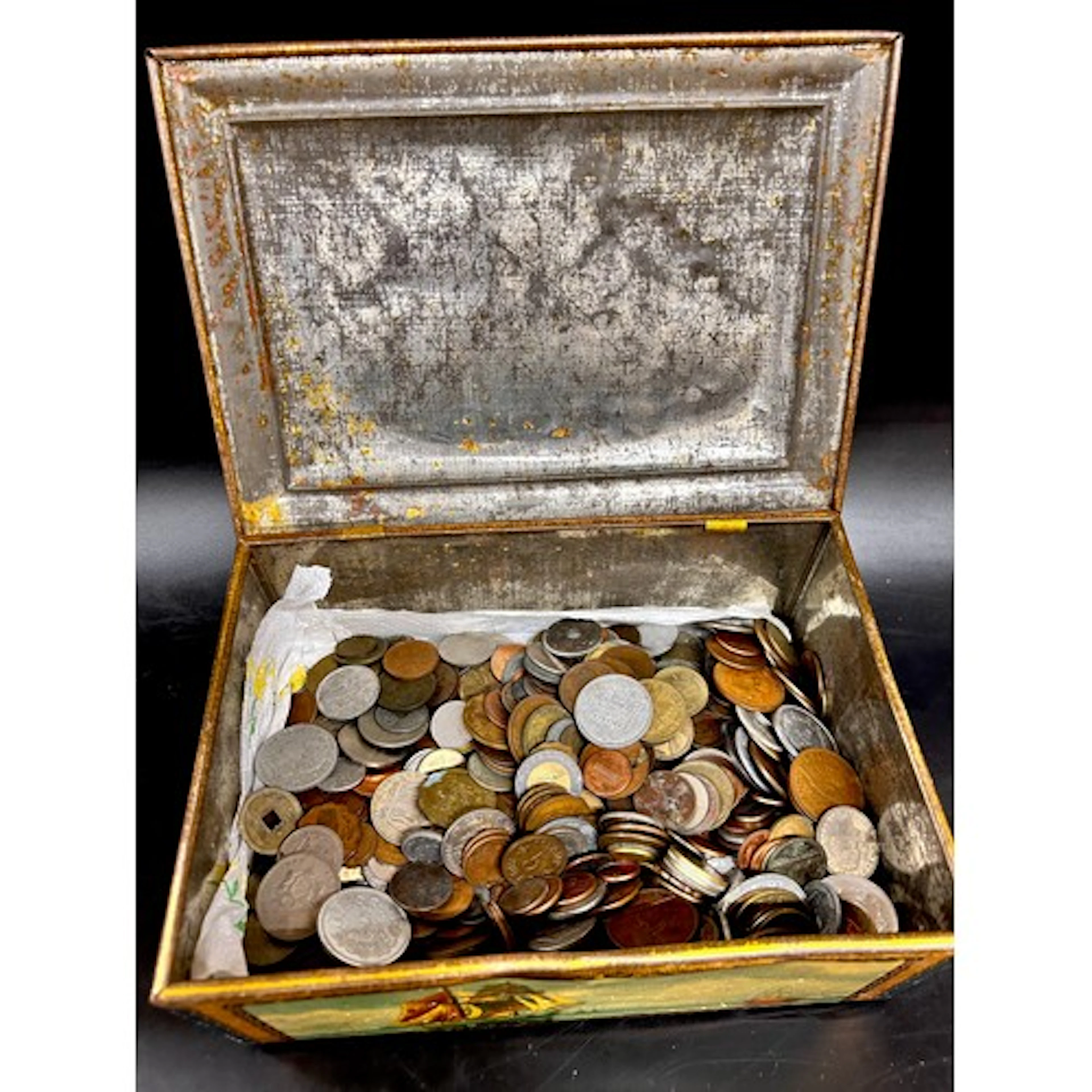 A tin of assorted world coins