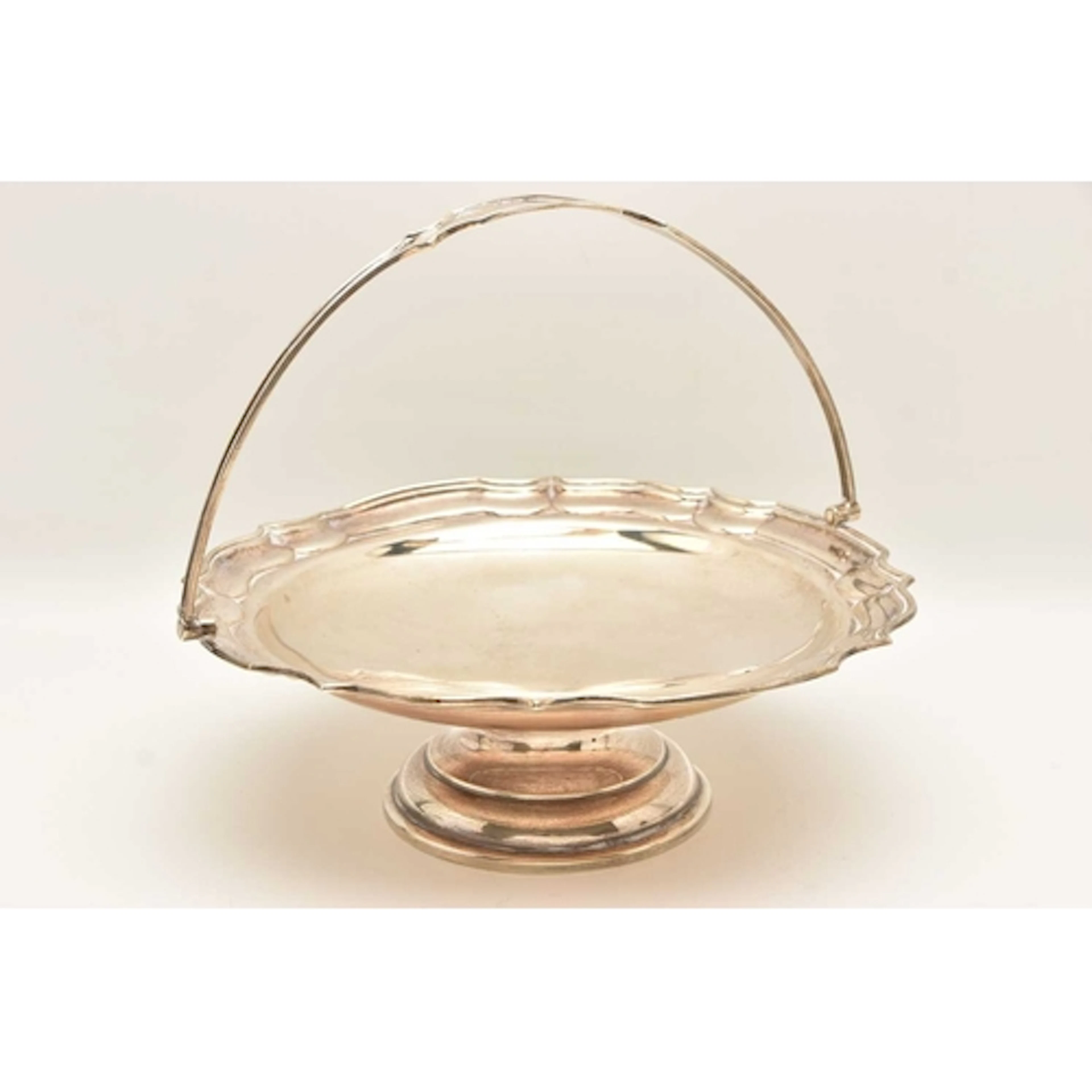 A GEORGE V SILVER PEDESTAL BASKET, of a circular wavy form f...