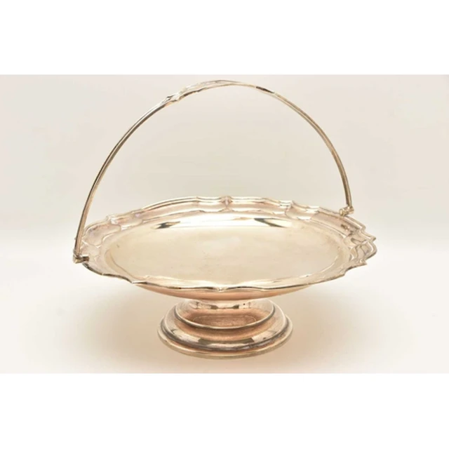 A GEORGE V SILVER PEDESTAL BASKET, of a circular wavy form f...