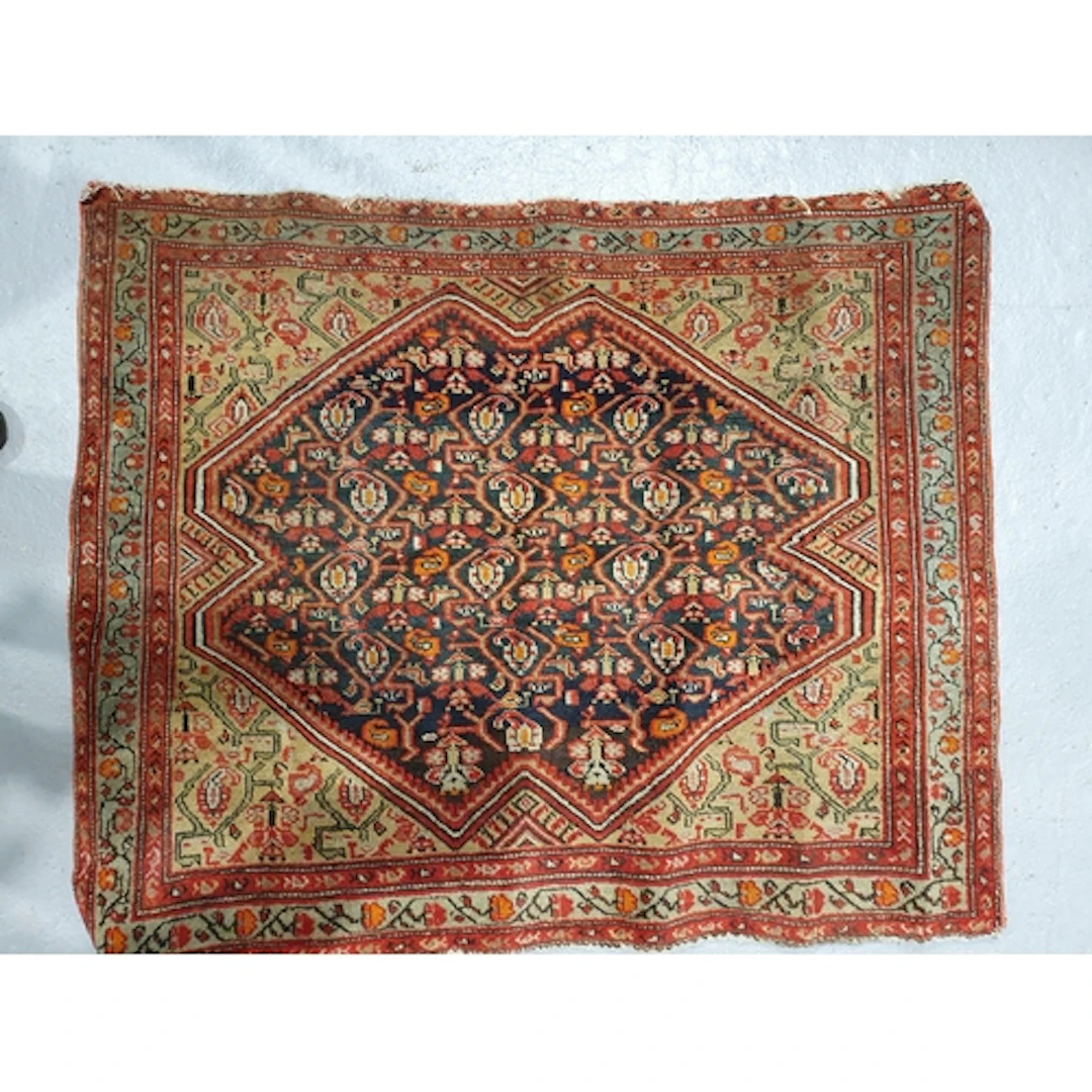An old bordered Persian Mat with central diamond lozenge con...