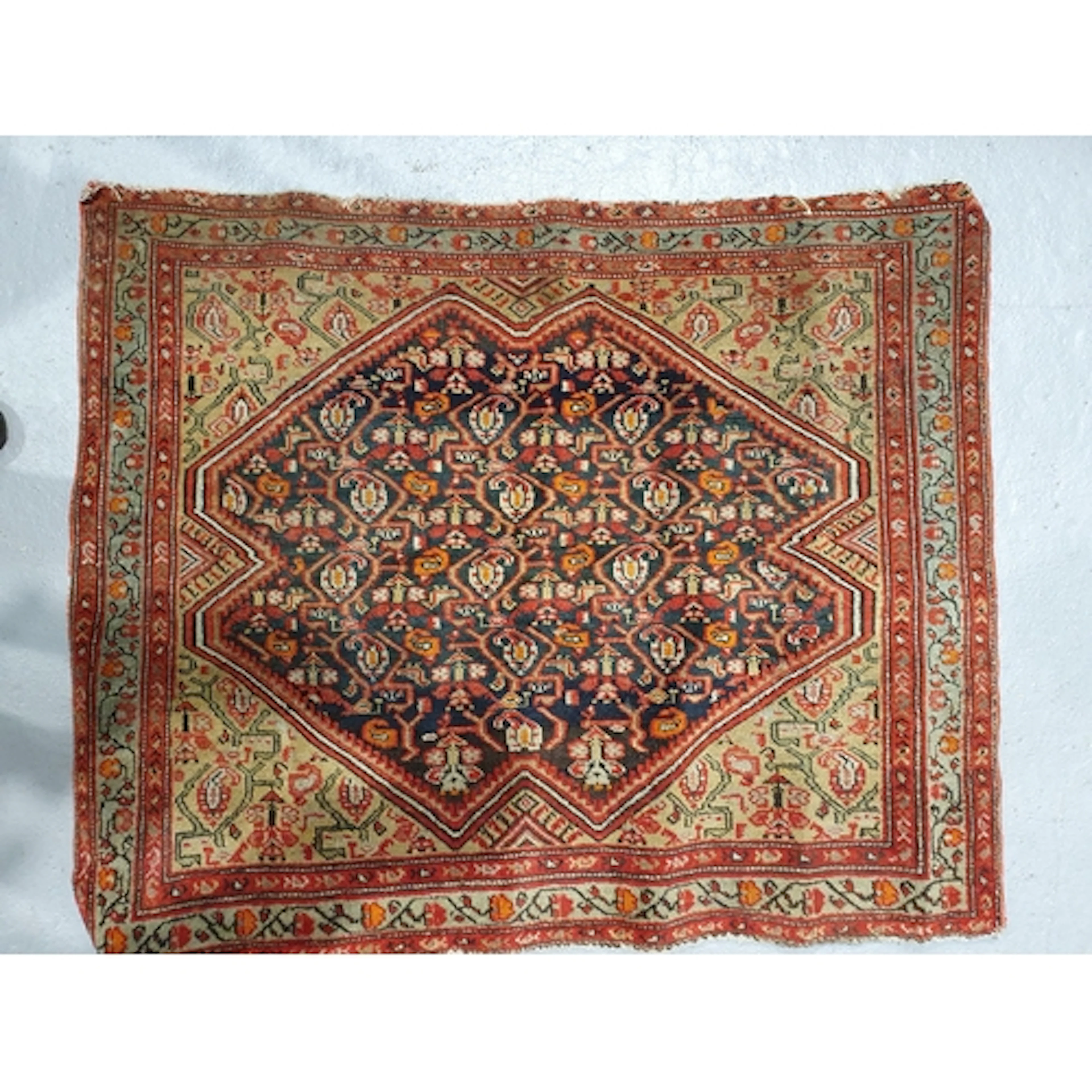 An old bordered Persian Mat with central diamond lozenge con...