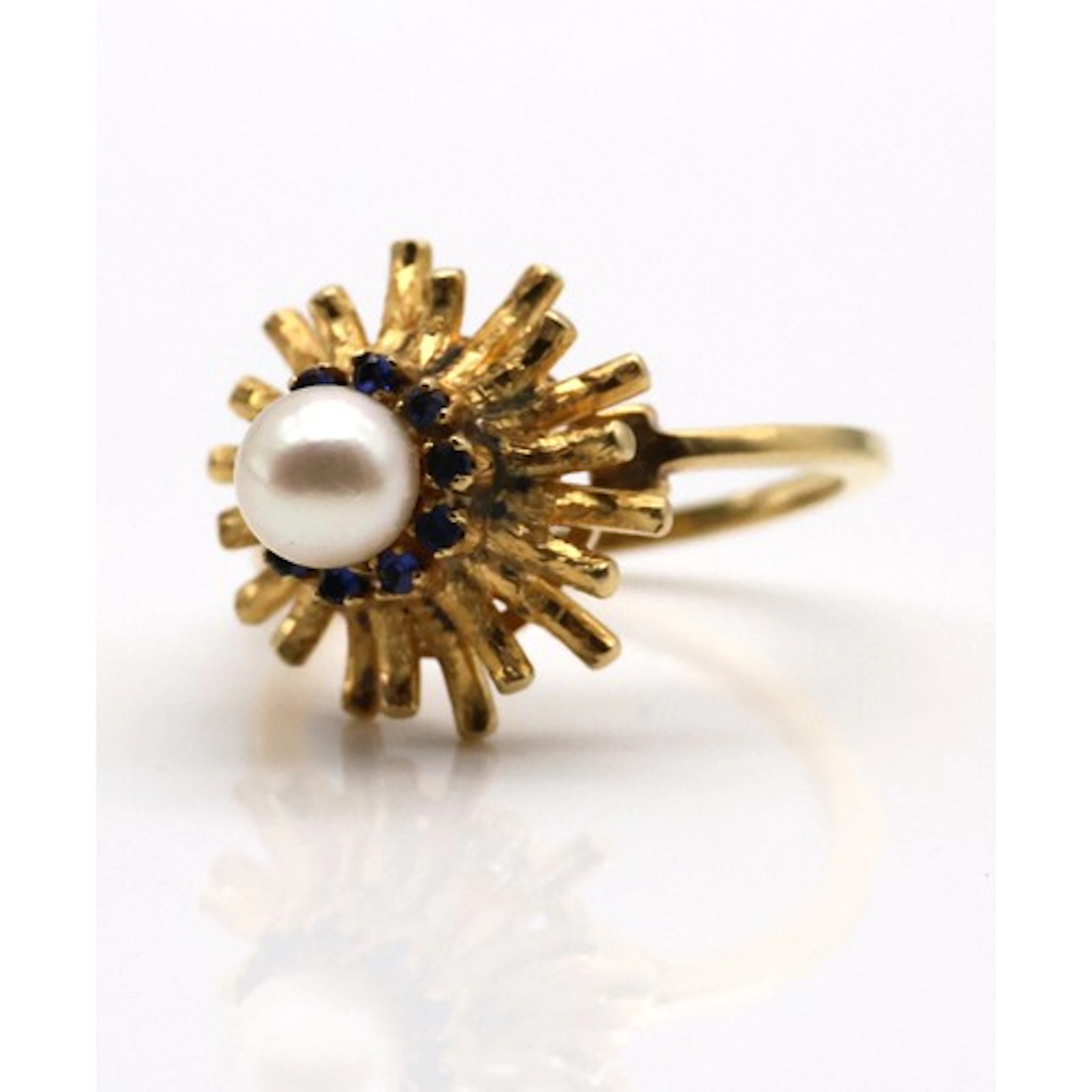 A pearl dress ring, centred with a pearl measuring 6mm, with...