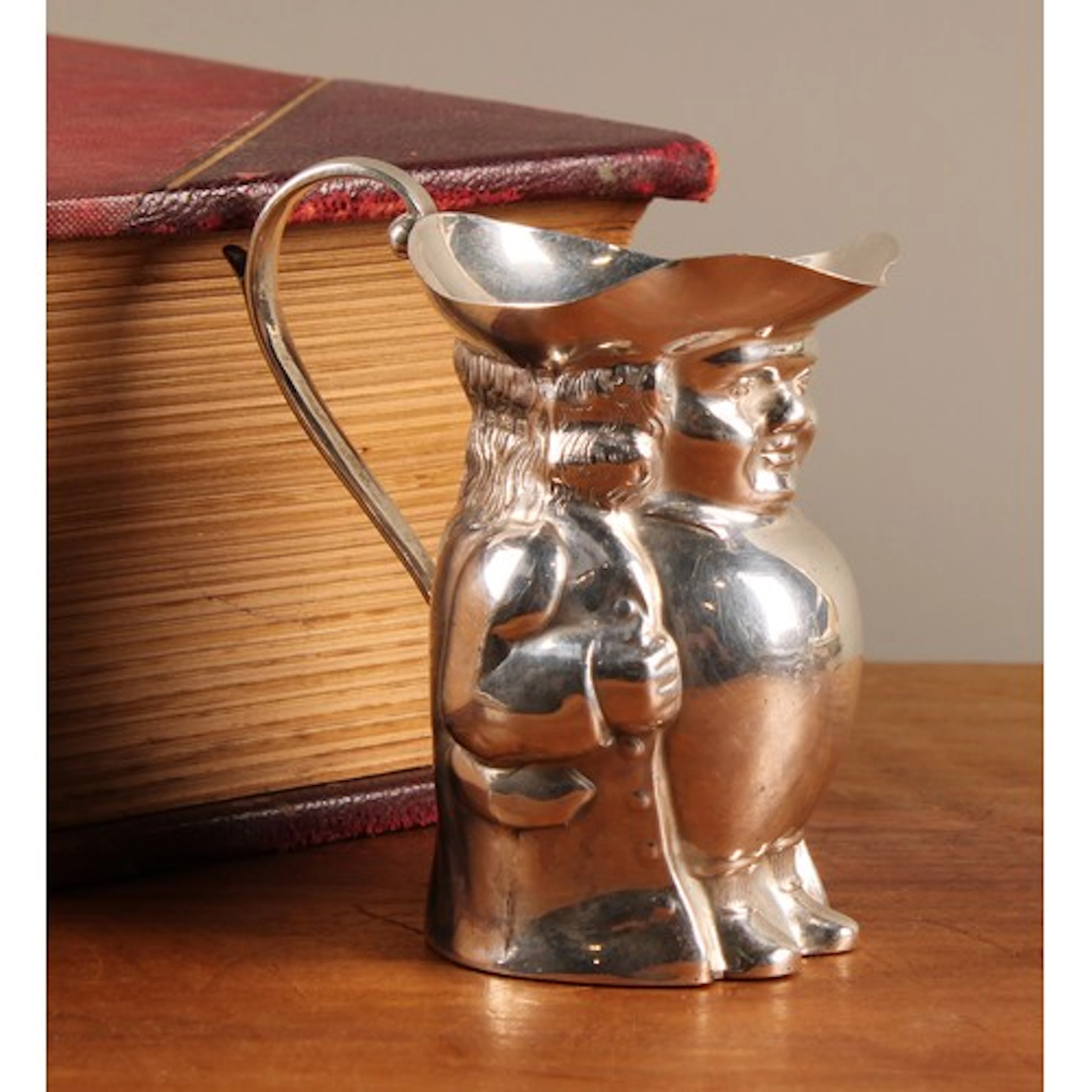 A George V silver novelty creamer, as a toby jug, 7.5cm high...