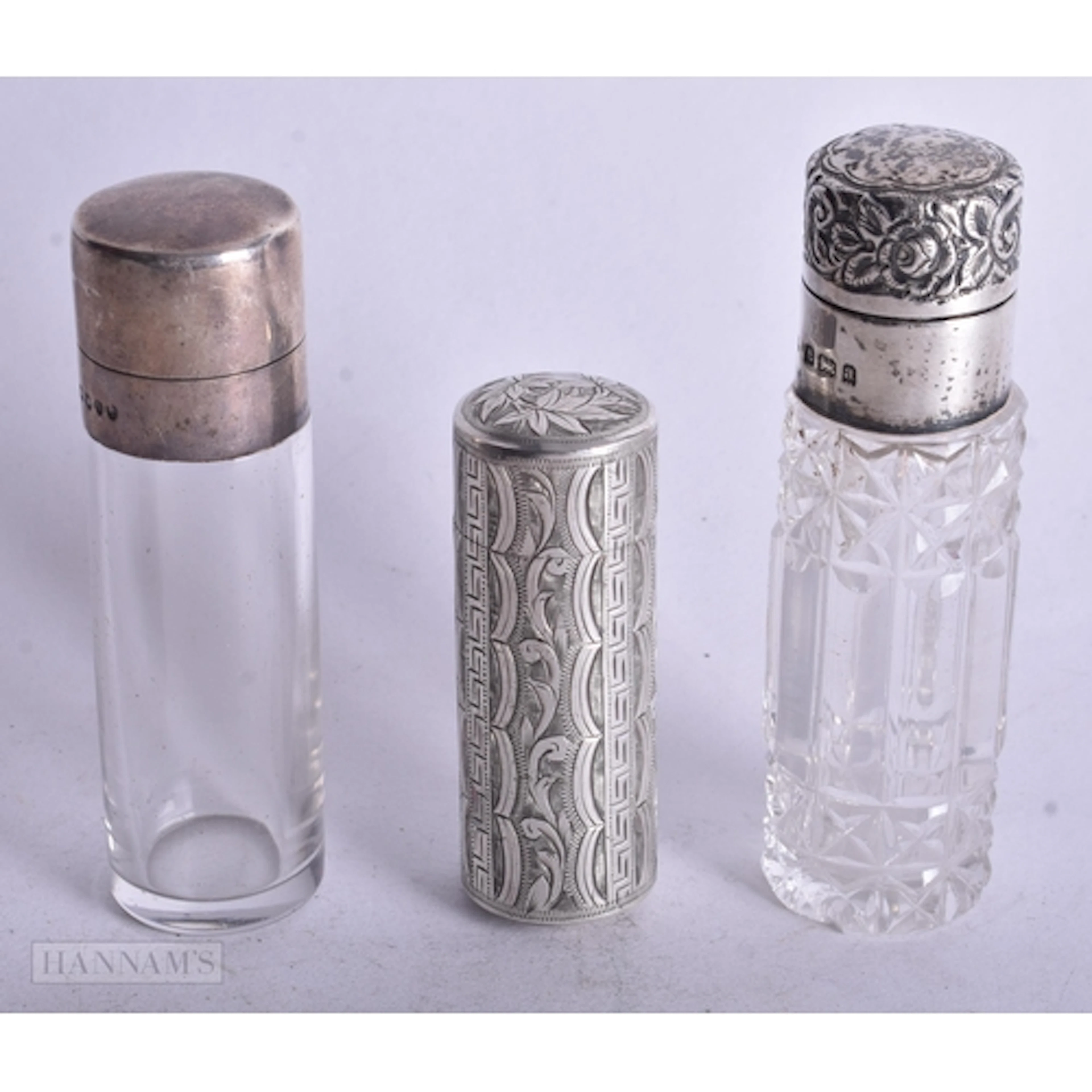 THREE ANTIQUE SILVER MOUNTED SCENT BOTTLES. Largest 8.5 cm h...