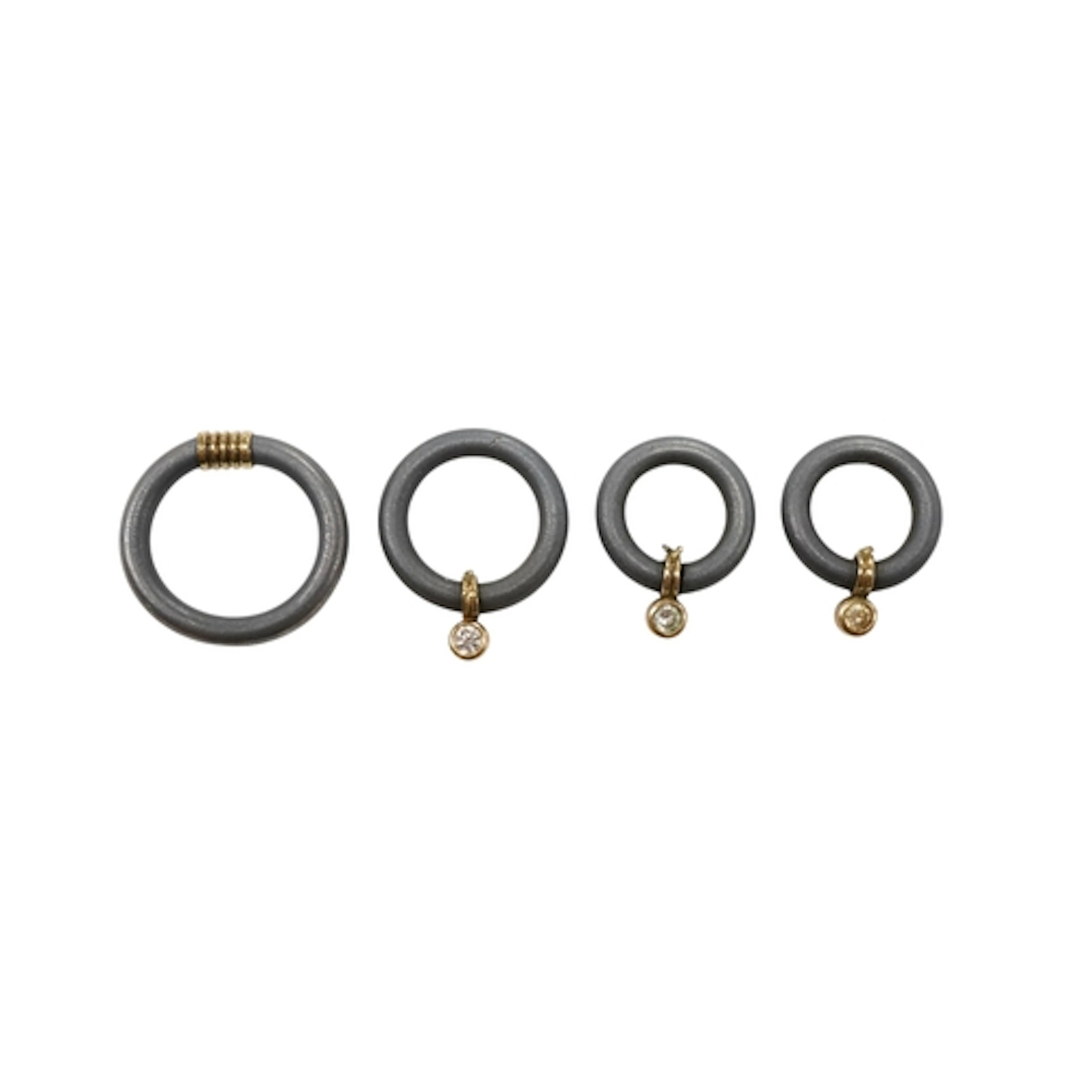 A modern titanium suite of jewellery, comprising a ring with...