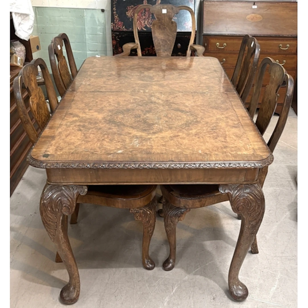 A 1930s burr walnut veneered table and 6 chairs (4+2 carvers...