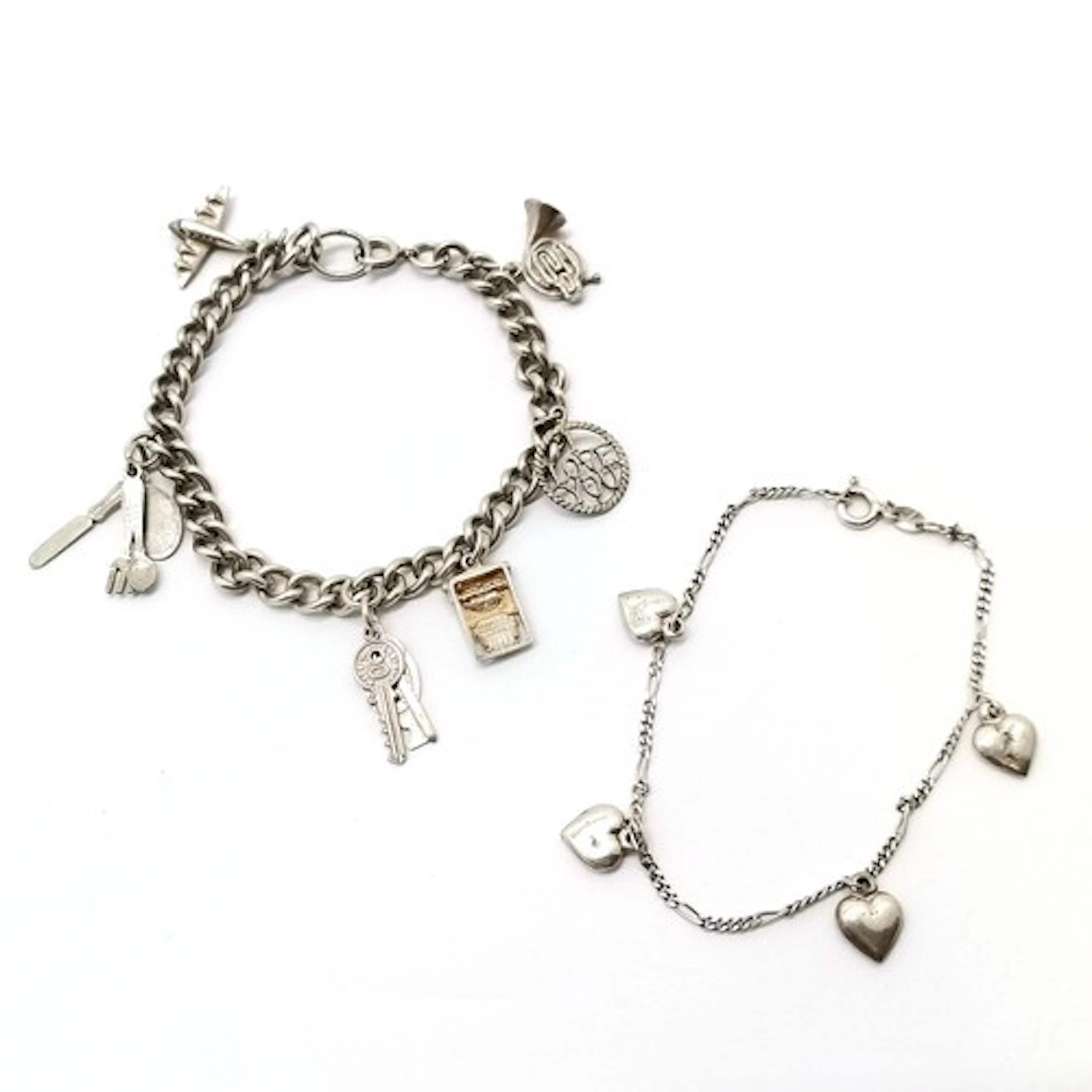 2 x Silver charm bracelets with charms inc typewriter, 'I lo...
