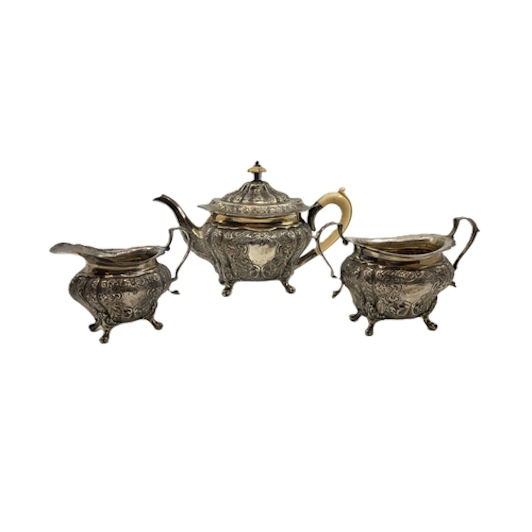 A THREE PIECE ANTIQUE EDWARDIAN STERLING SILVER EMBOSSED BAC...