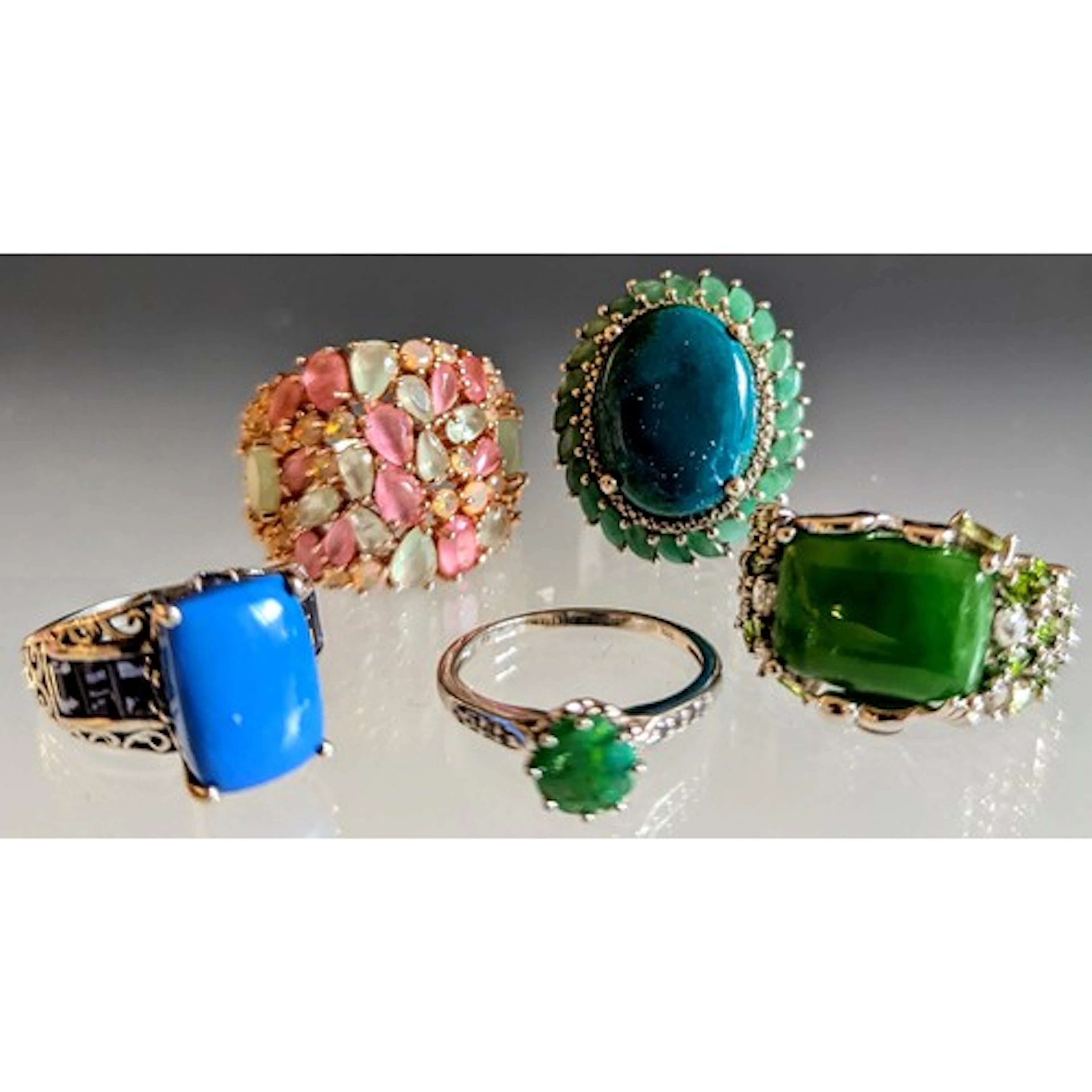 Five silver rings, to include a "925" stamped cabochon dyed...