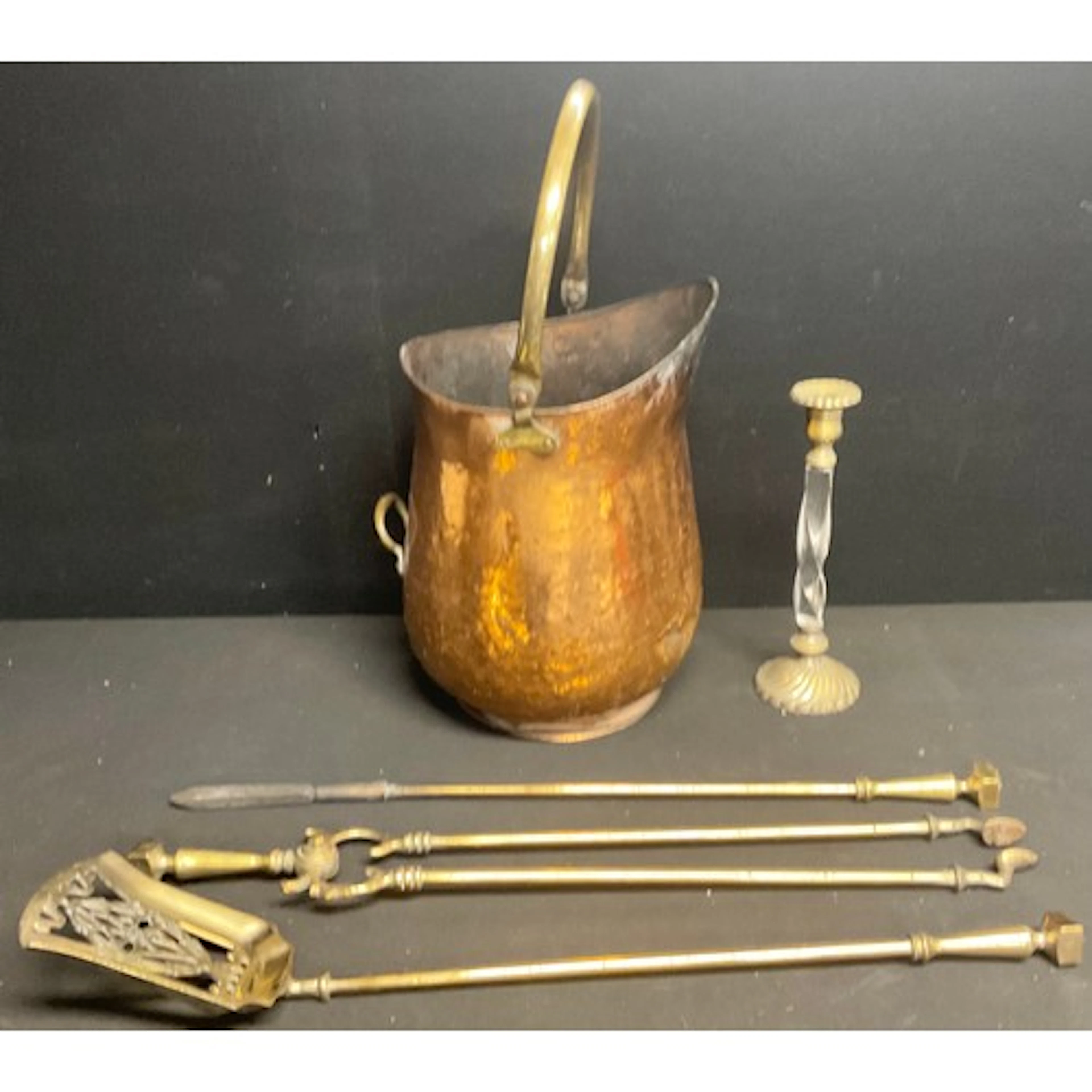 A set of early 20th century brass fire irons or fireside com...