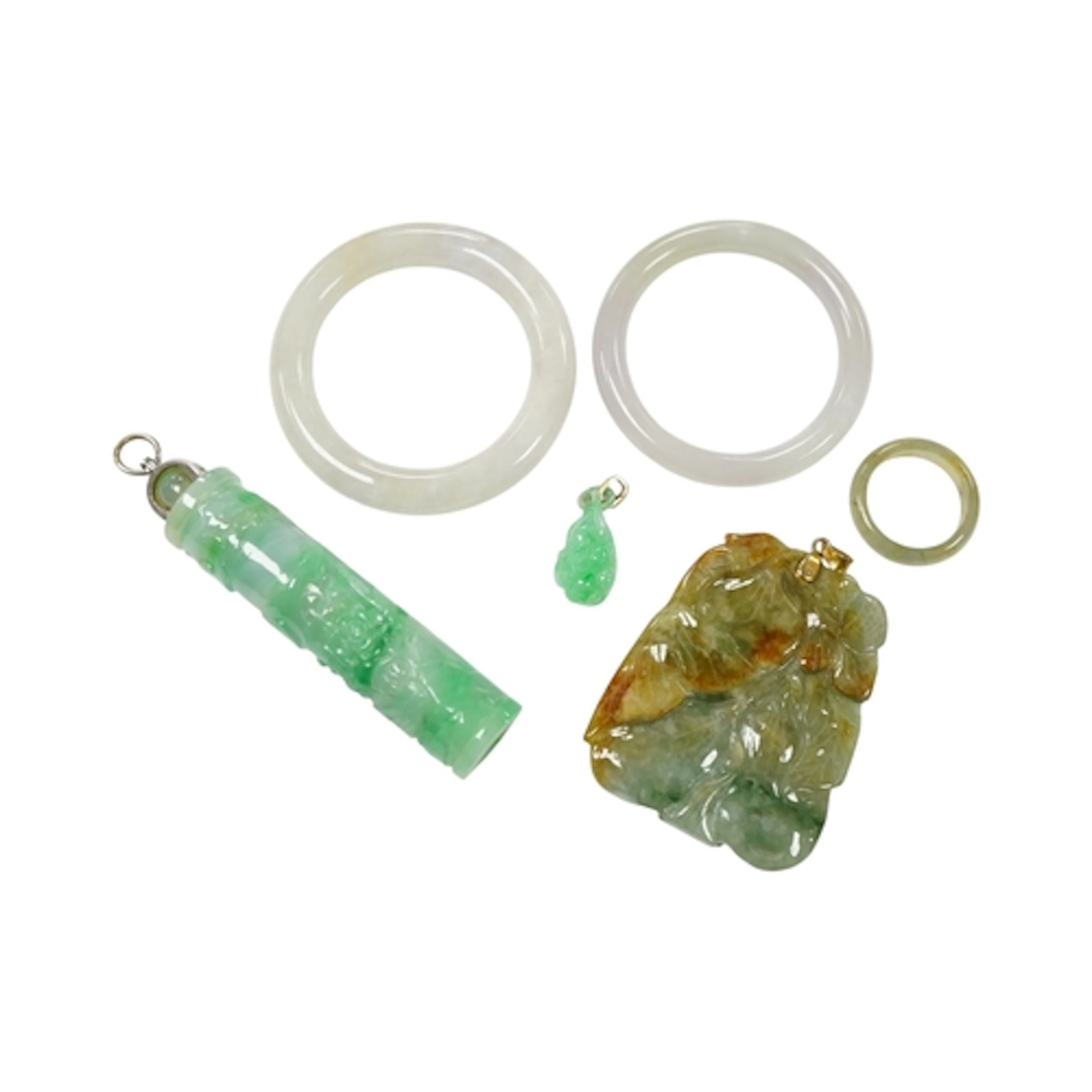 A collection of jadeite jewels, to include three carved pend...