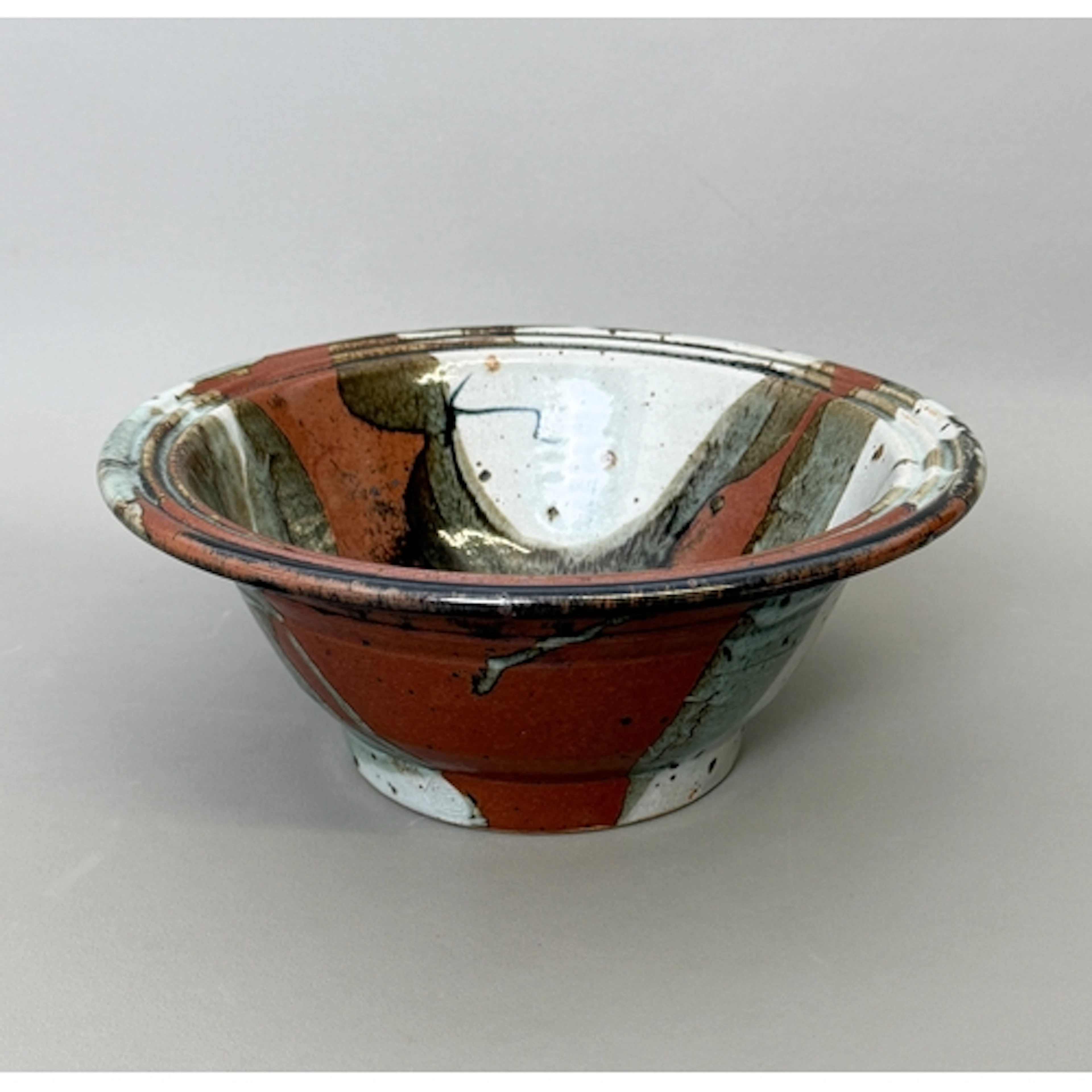 A studio pottery footed bowl - in grey and terracotta glaze ...