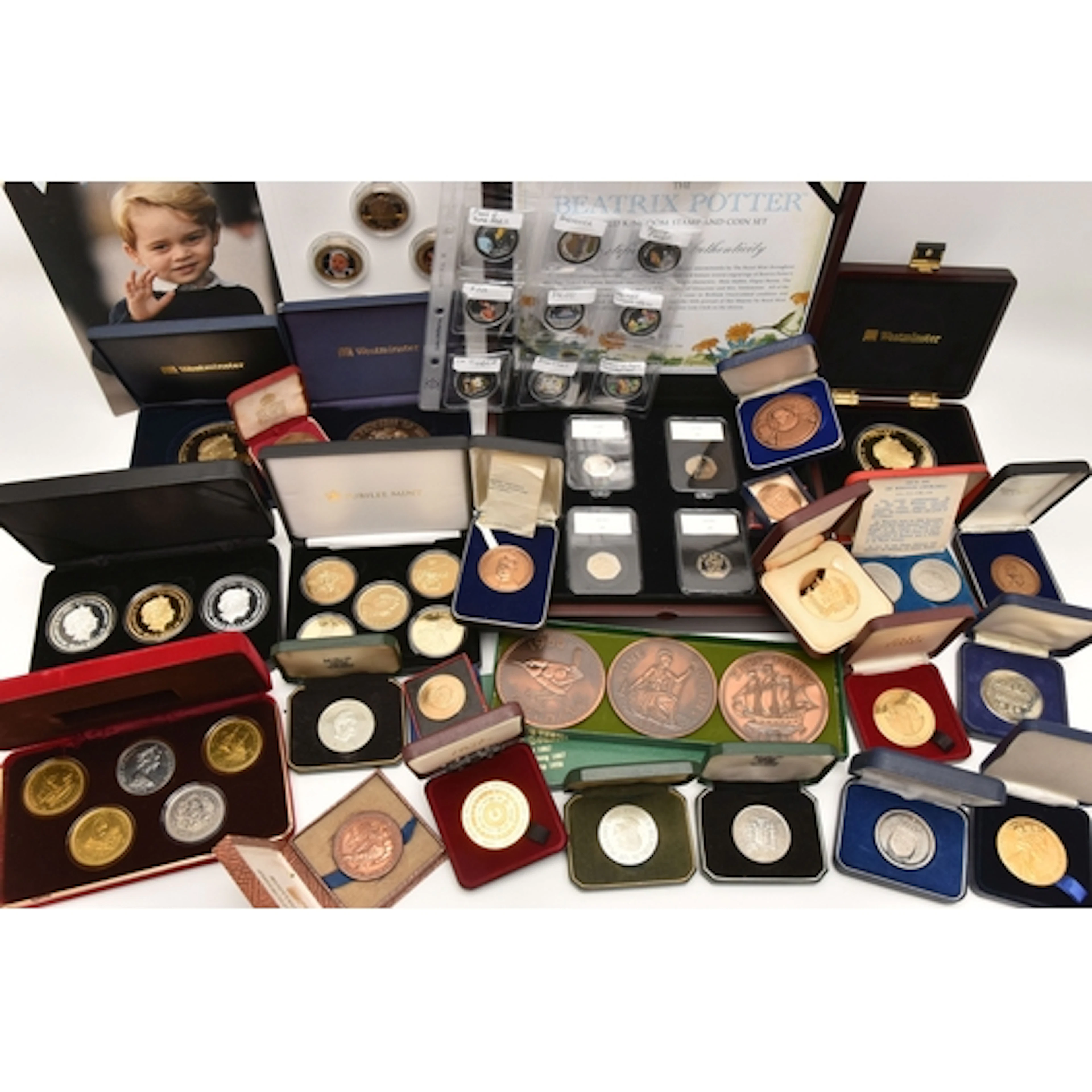 A box containing Commemorative sets and single Commemorative...