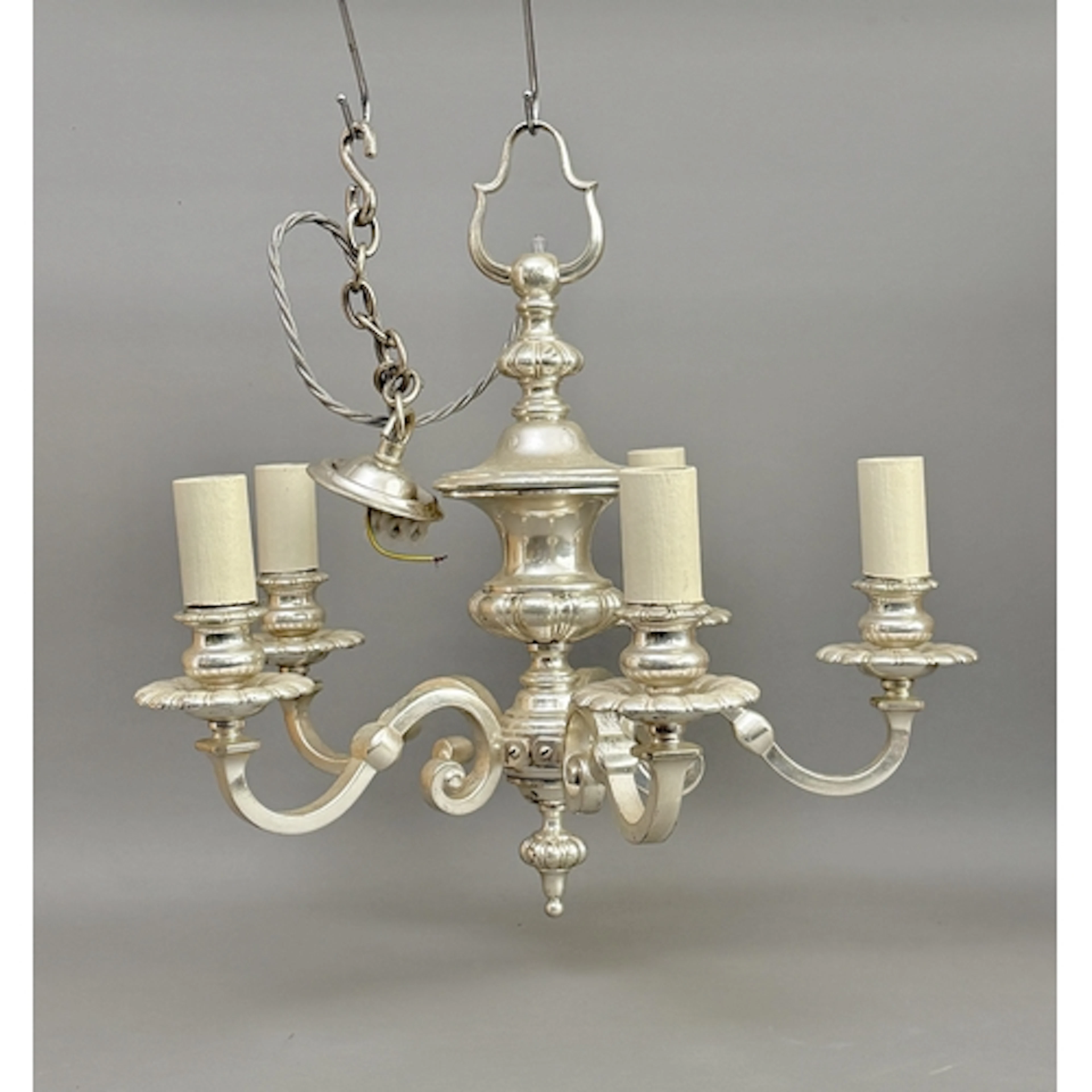 A silvered five branch brass chandelier in the Georgian styl...