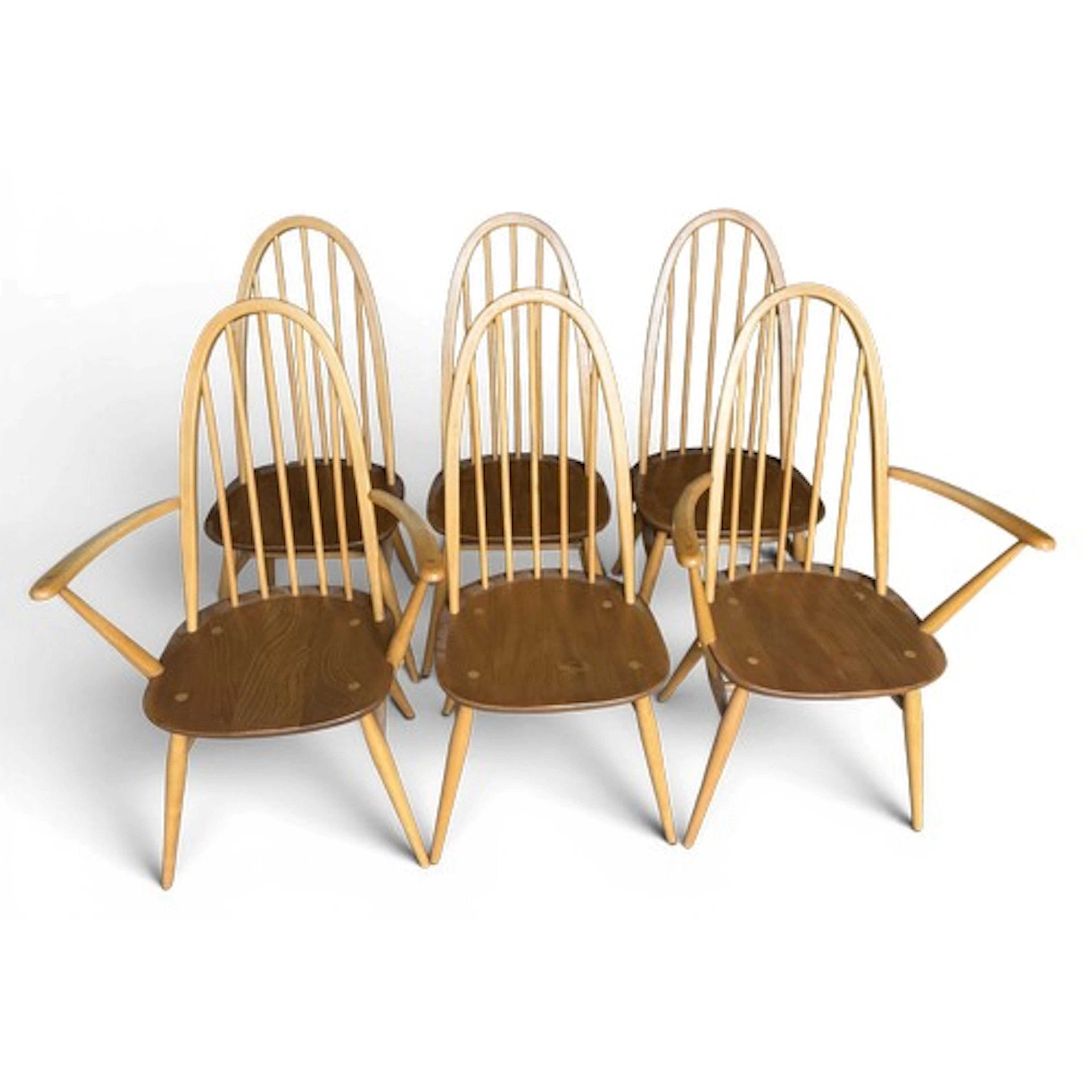 Six mid 20thC Ercol stick back chairs to include 2 carvers. ...