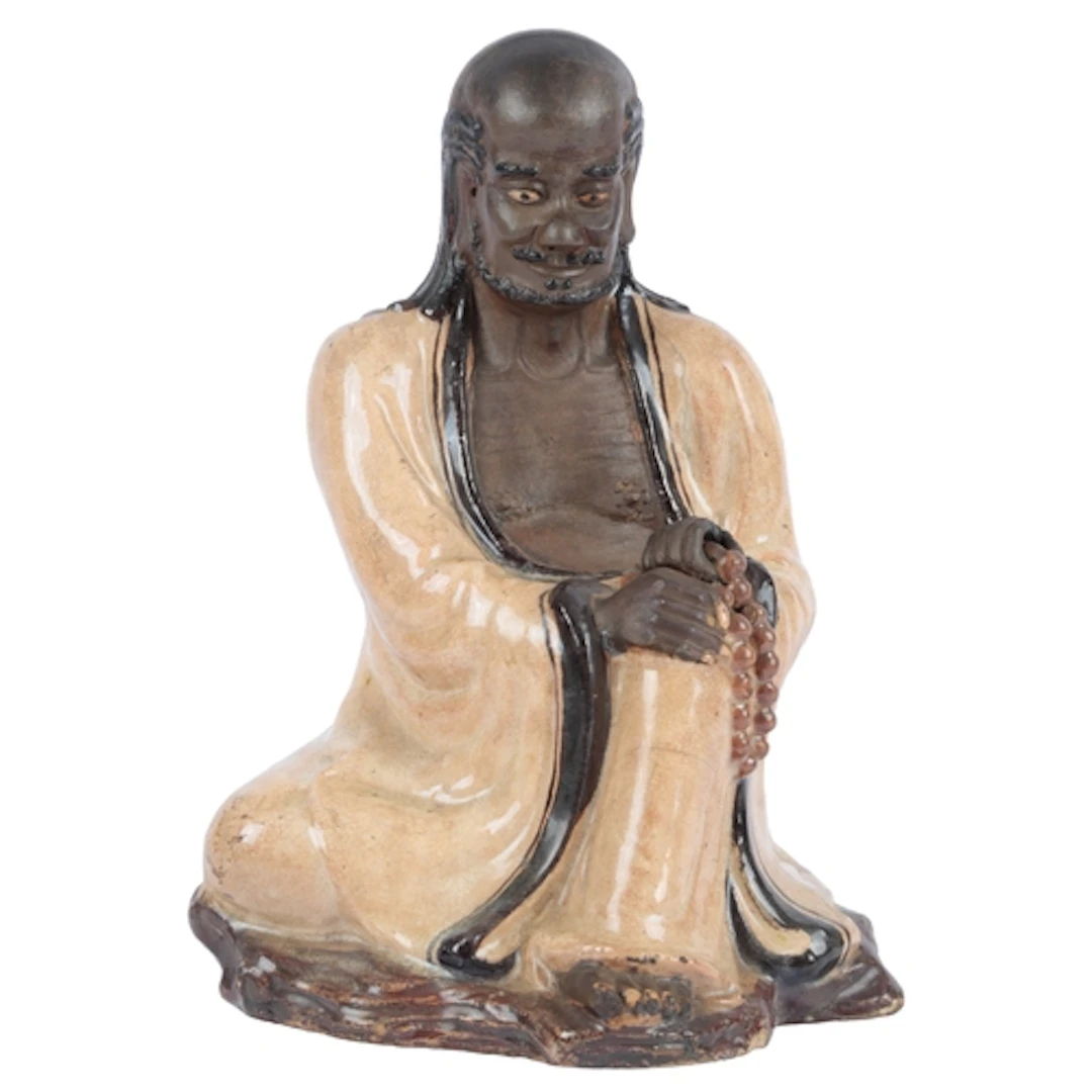 A Chinese Shiwan seated figure of Bodhidharma, 19th century,...