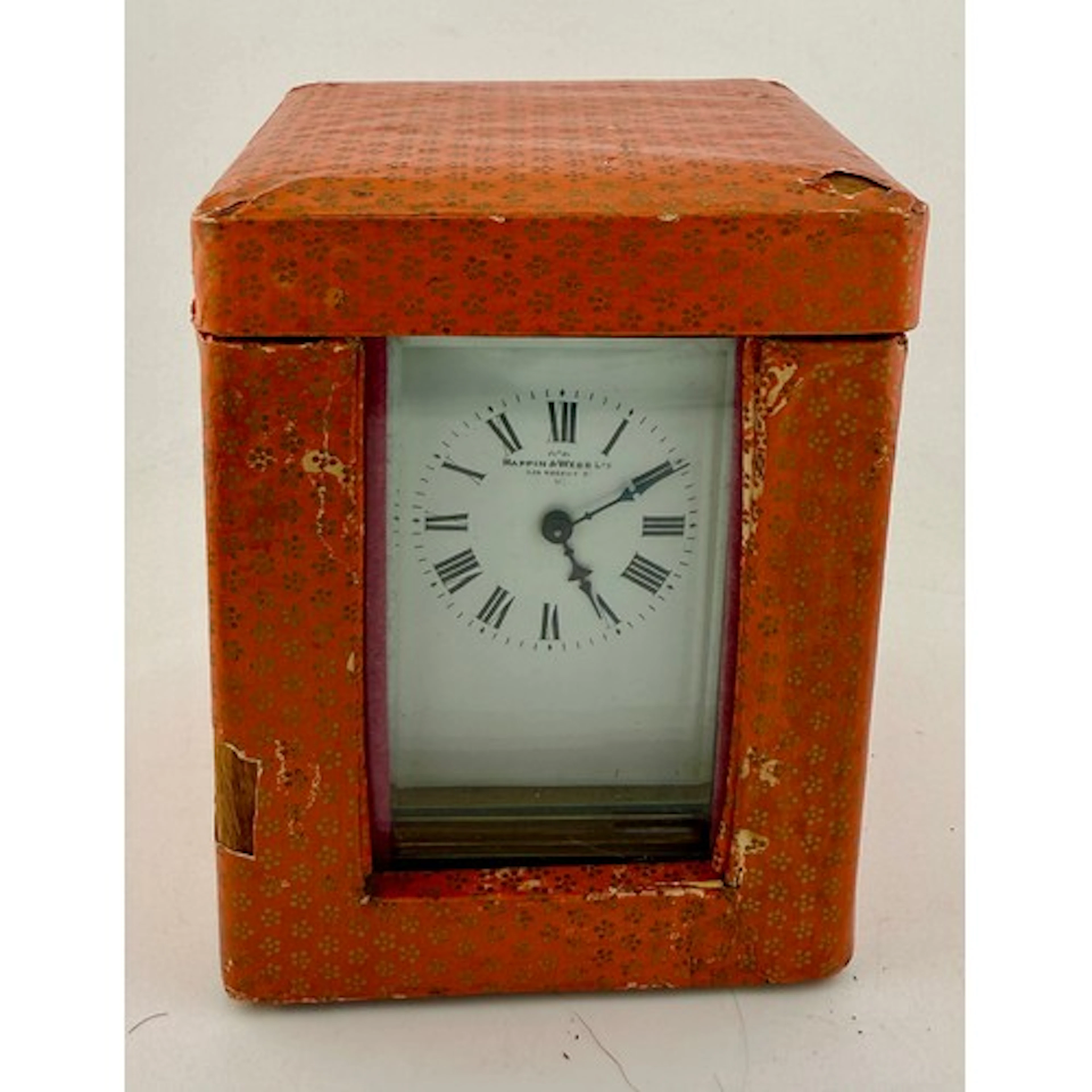 A brass cased carriage clock in outer case with key. Marked ...