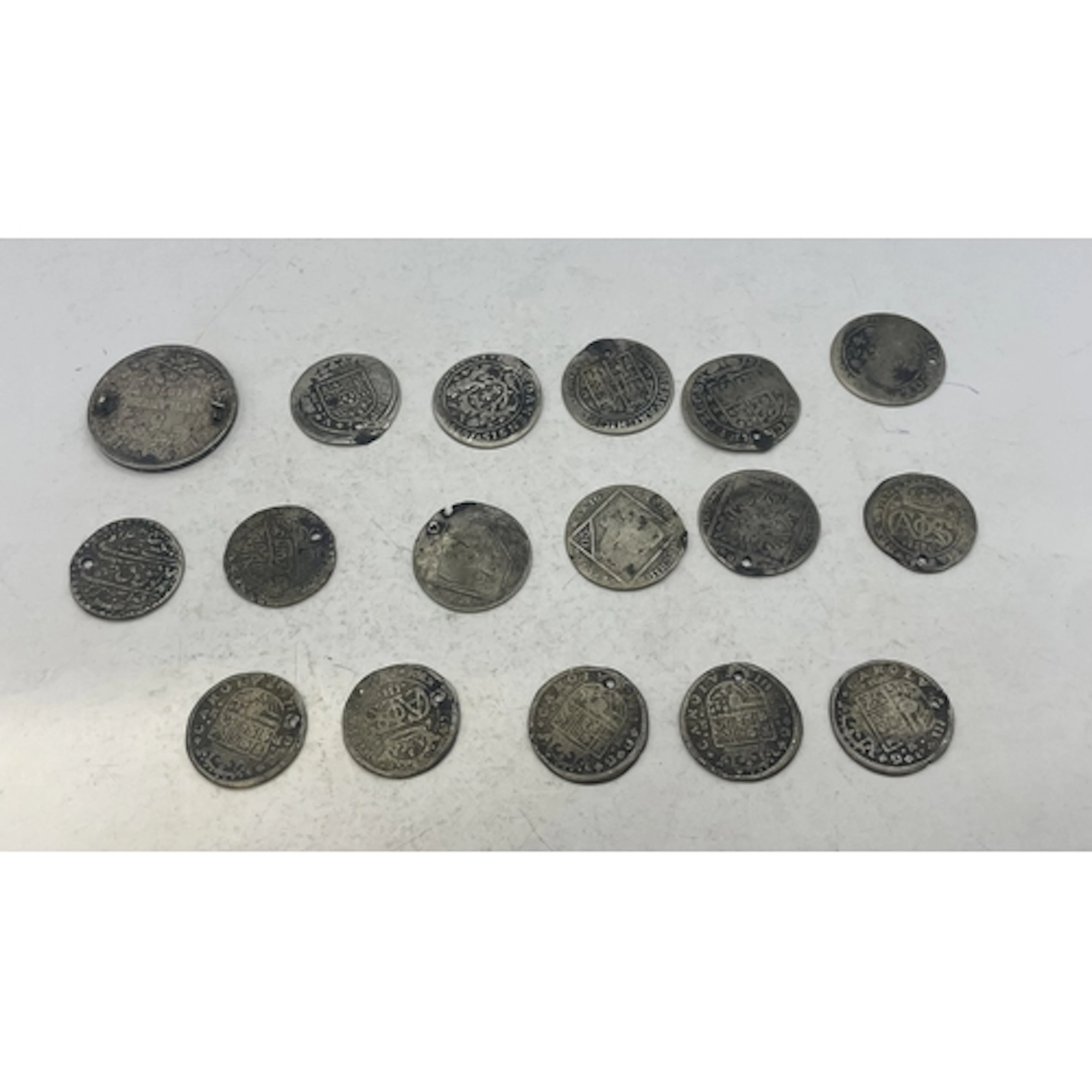 Various silver coins, all containing holes or other alterati...