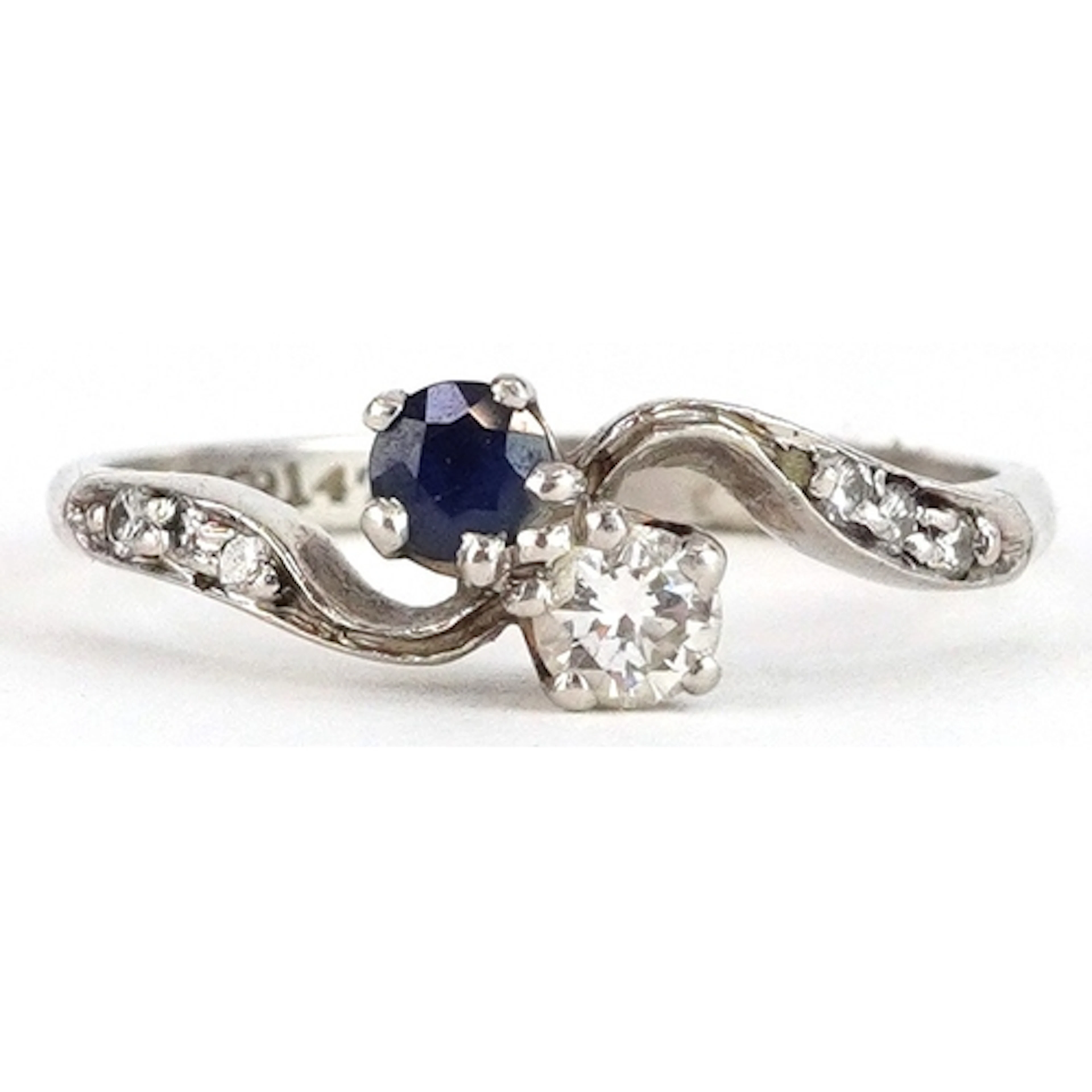 White metal diamond and sapphire crossover ring, indistinct ...
