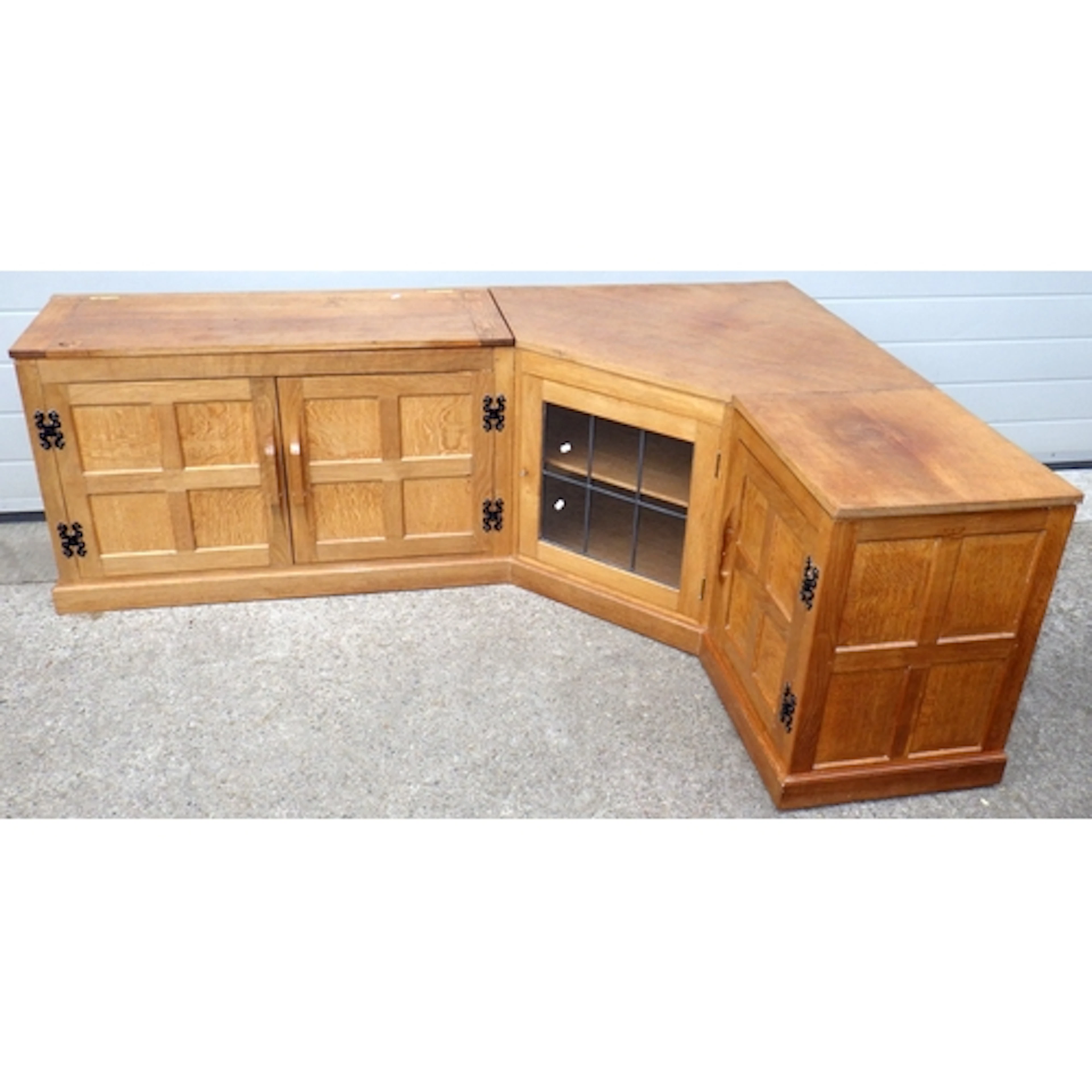 A Fish motif adzed oak corner entertainment unit with leaded...