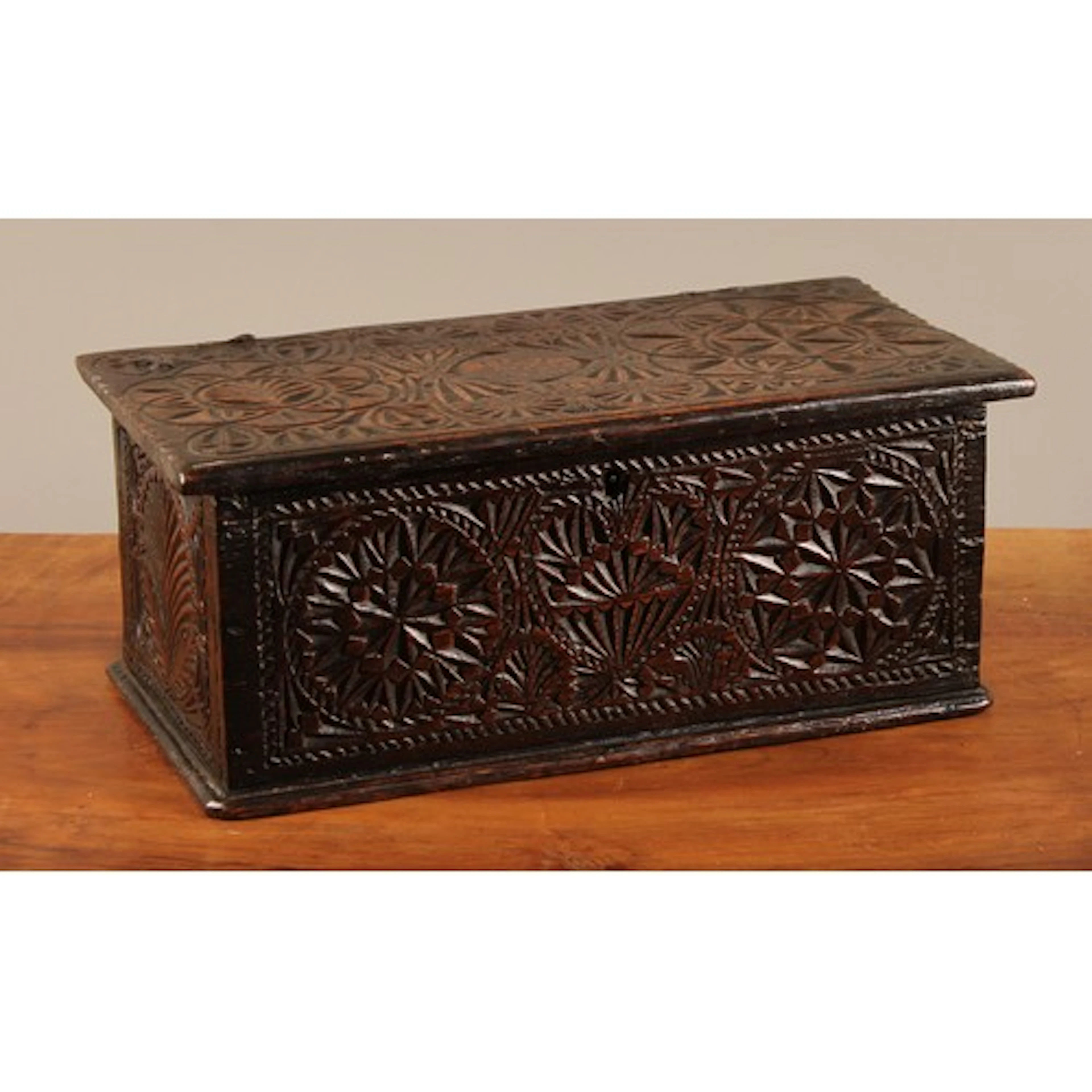 A 17th century oak chip carved boarded box, probably a love ...