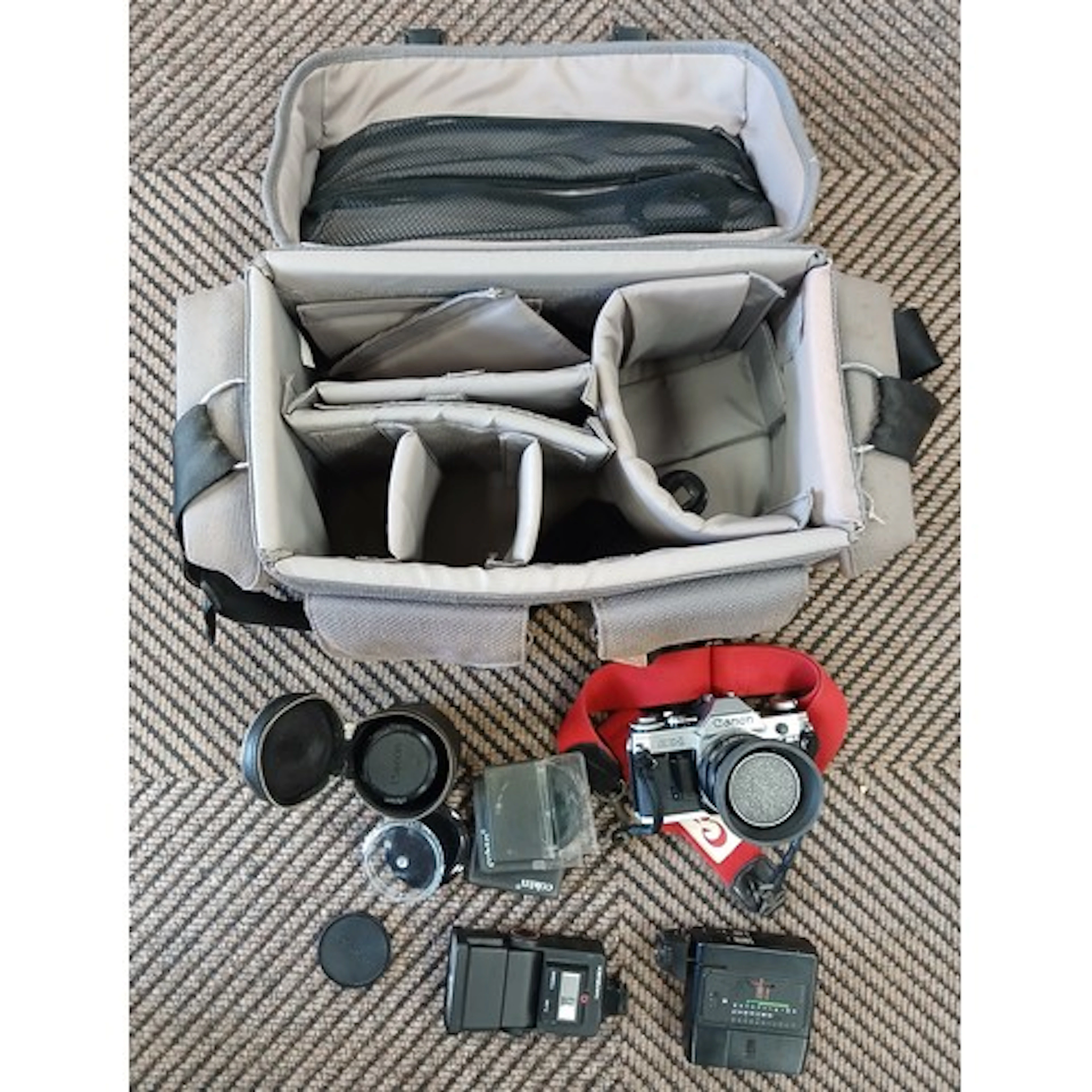 Canon AE-1 camera with accessories, lenses, and various came...