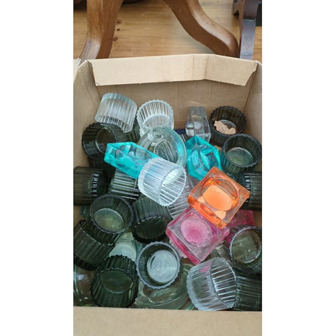 A quantity of pressed-glass tealight holders.